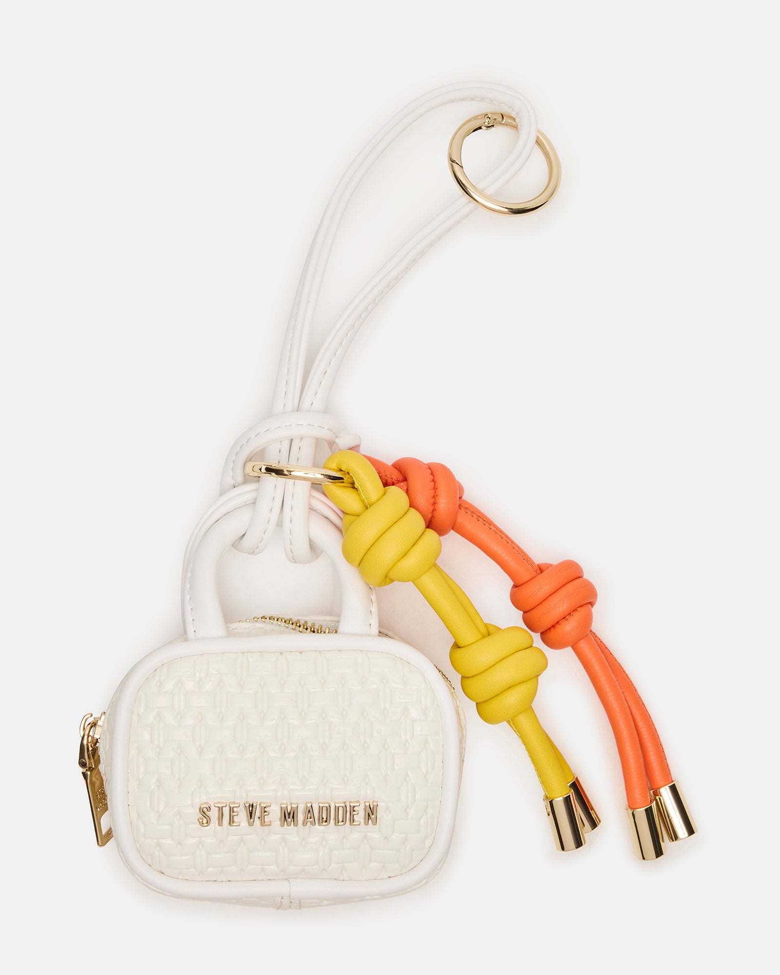 Close-up of Coach Cruise bag charm showing zipper and tubular structure.