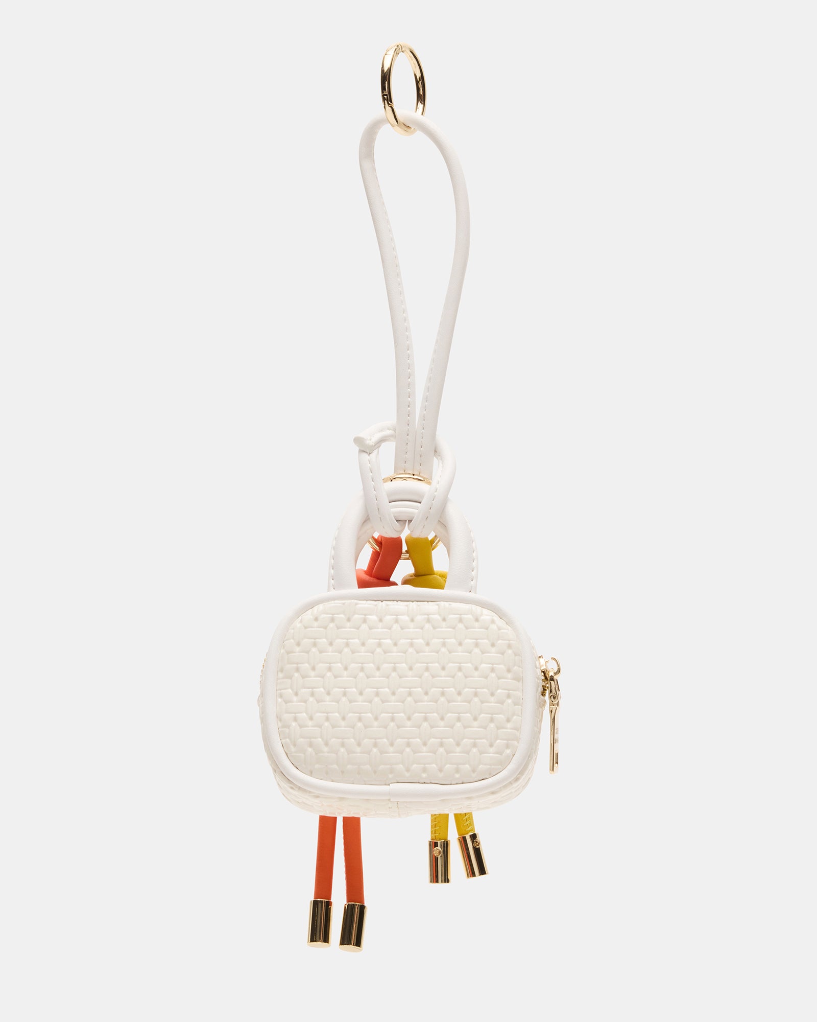 Close-up of Coach Cruise bag charm showing zipper and tubular structure.