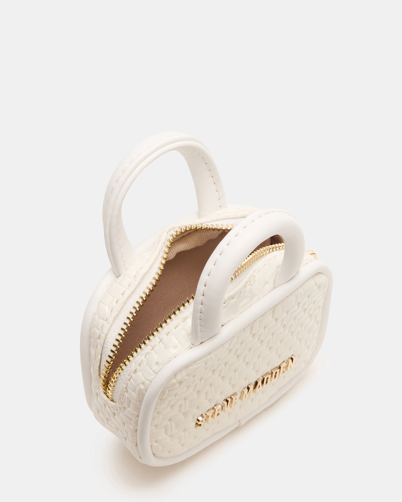 White Multi charm displayed next to headphones to illustrate compact size.