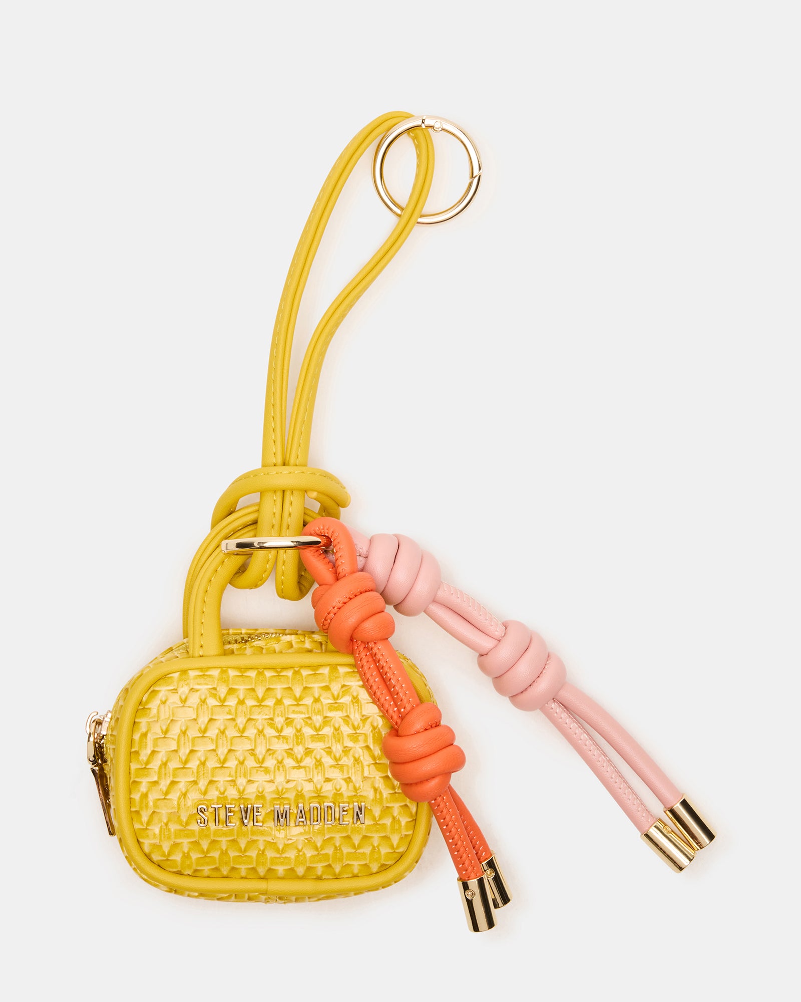Close-up of Coach Cruise bag charm showing zipper pouch and charms