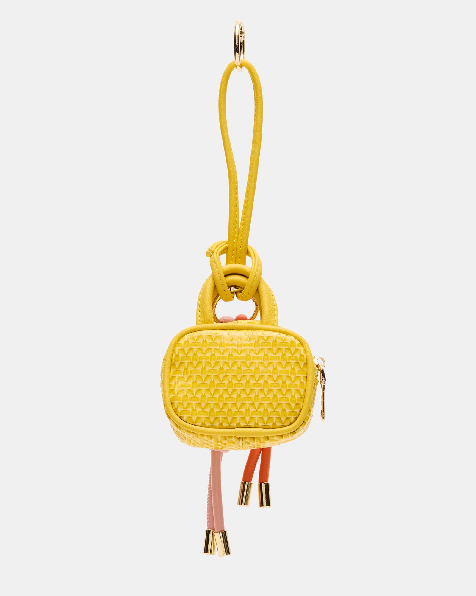 Close-up of Coach Cruise bag charm showing zipper pouch and charms