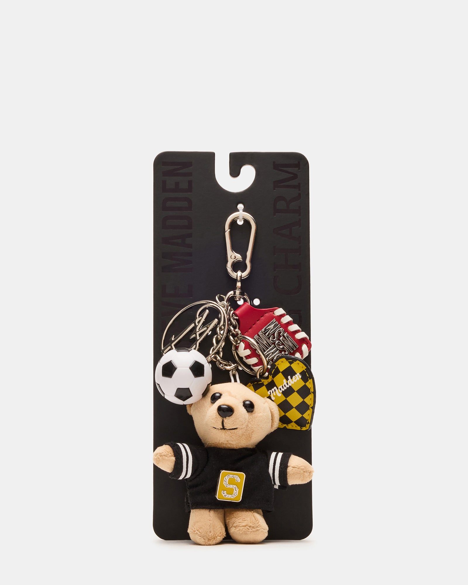 Soccer bear bag charm on a black handbag, showcasing its playful design.