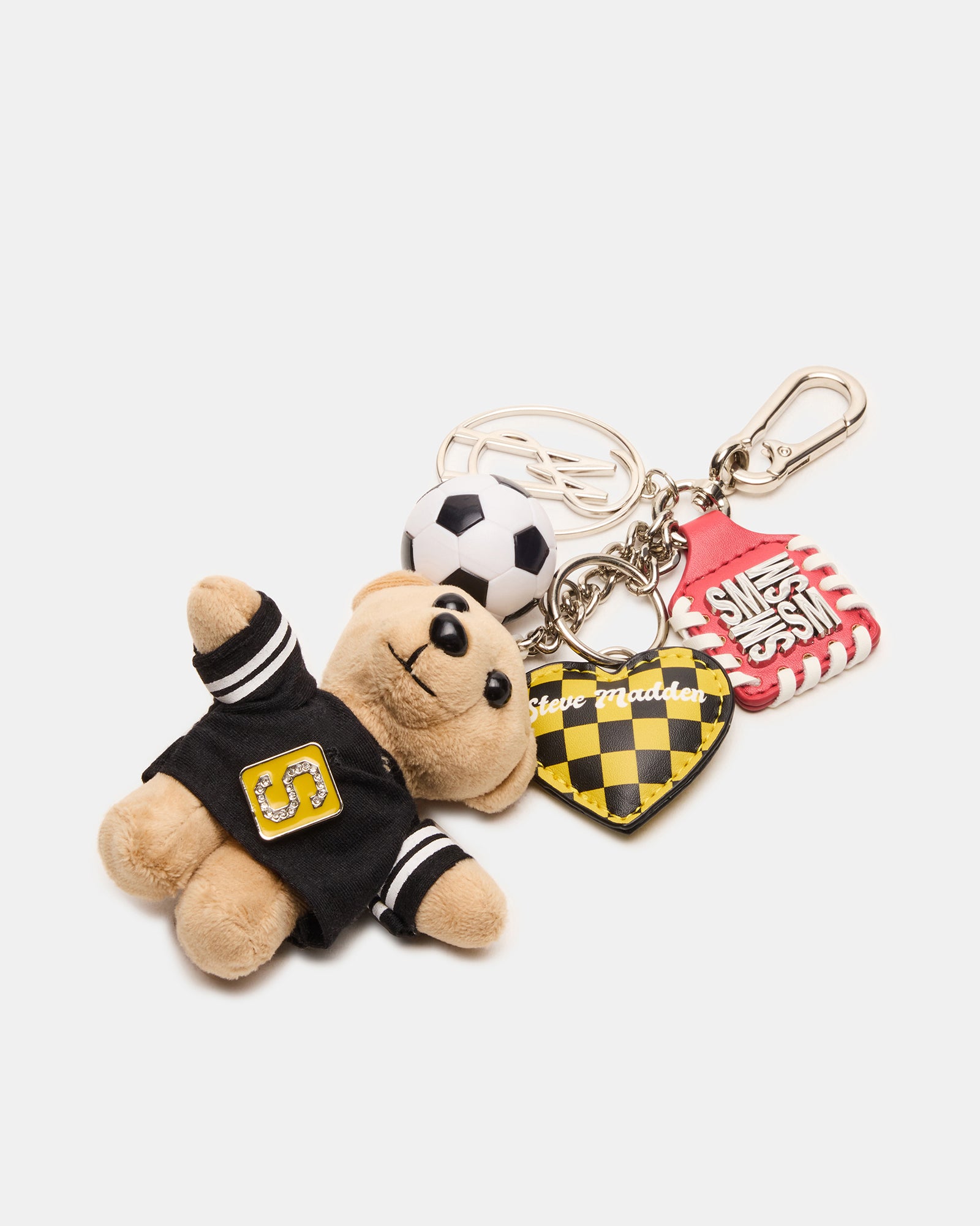 Close-up of the soccer bear bag charm with a heart charm.