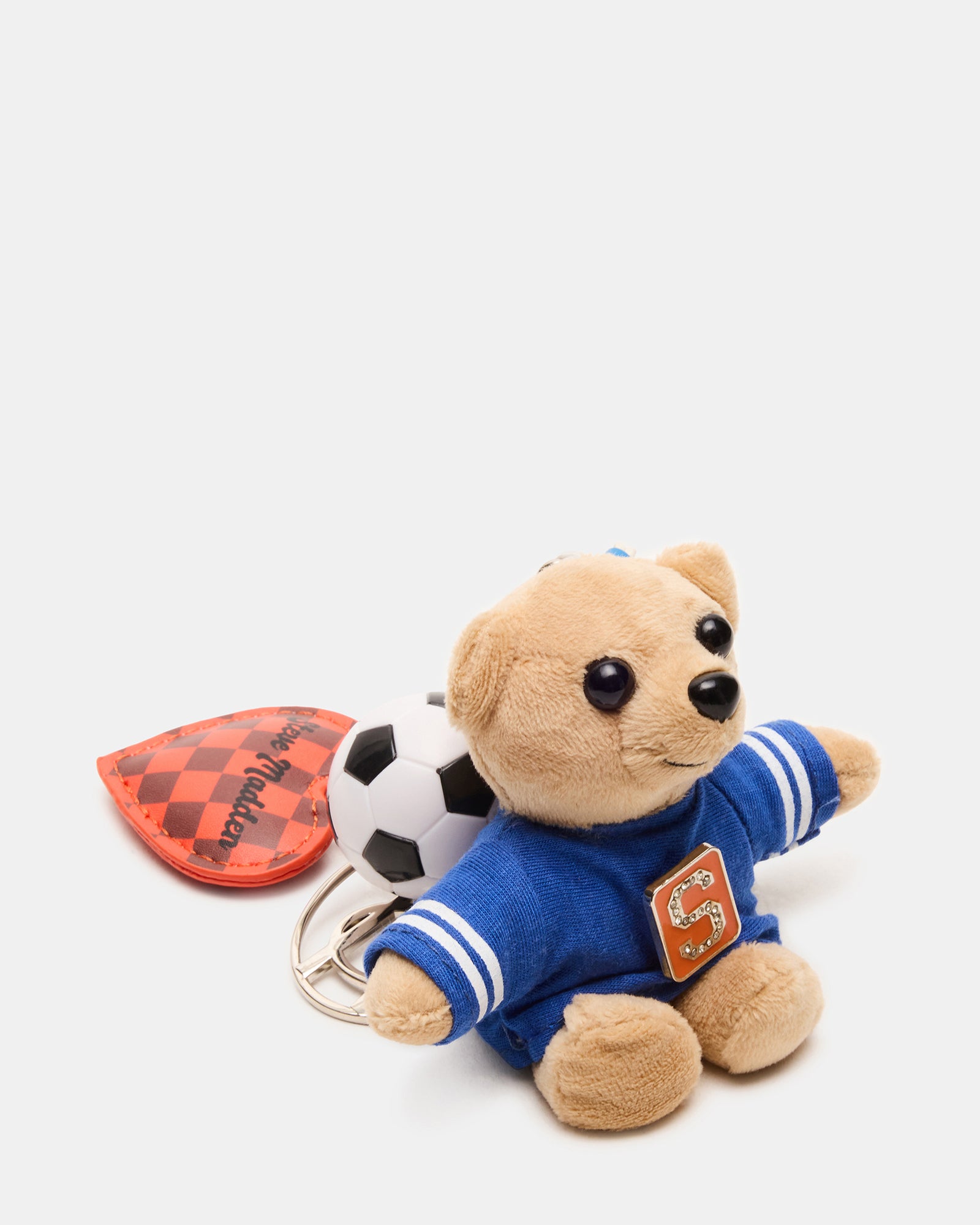 Over-the-shoulder shot of charm attached to leather backpack outdoors