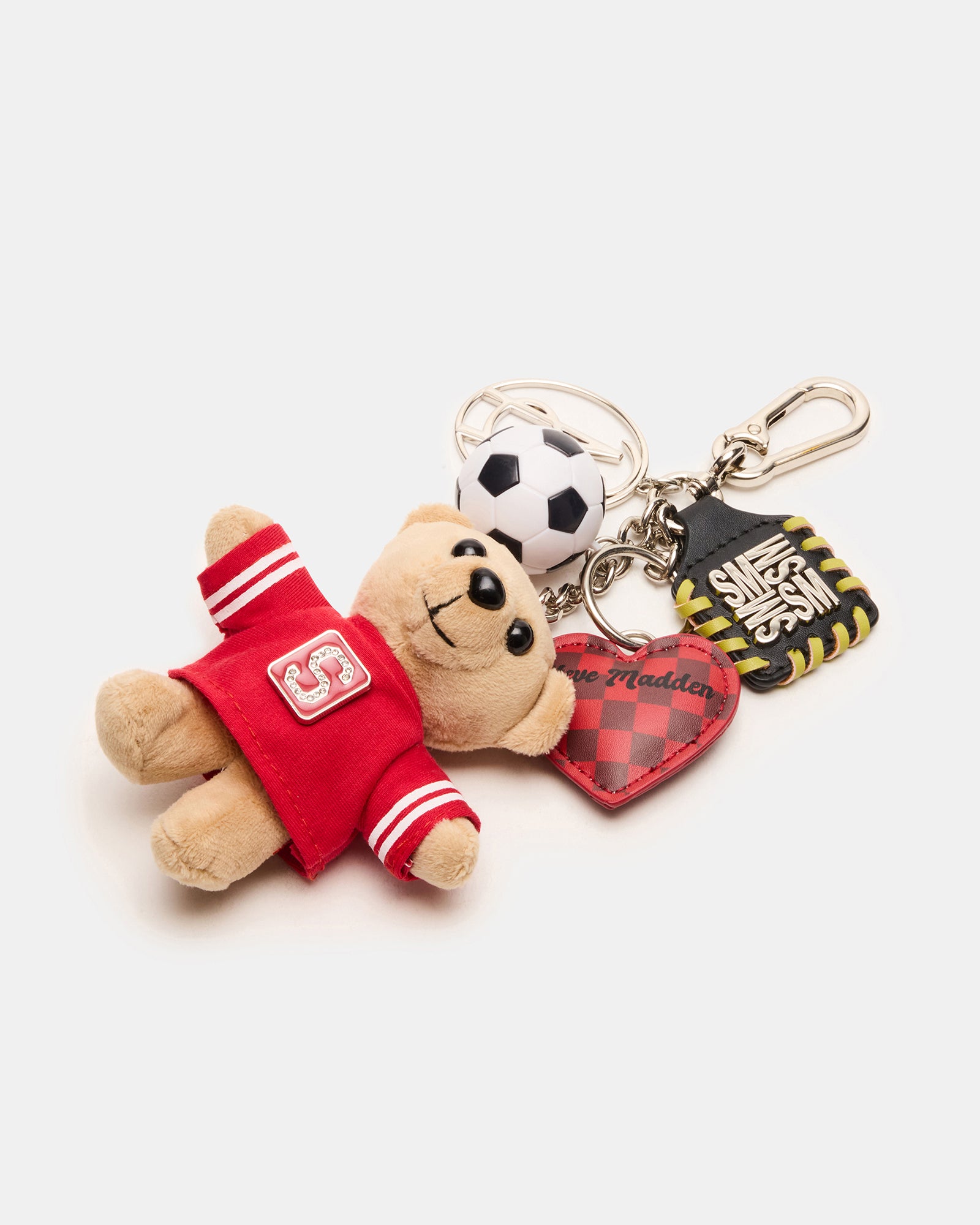 Close-up of the plush bear and soccer ball charm on a handbag