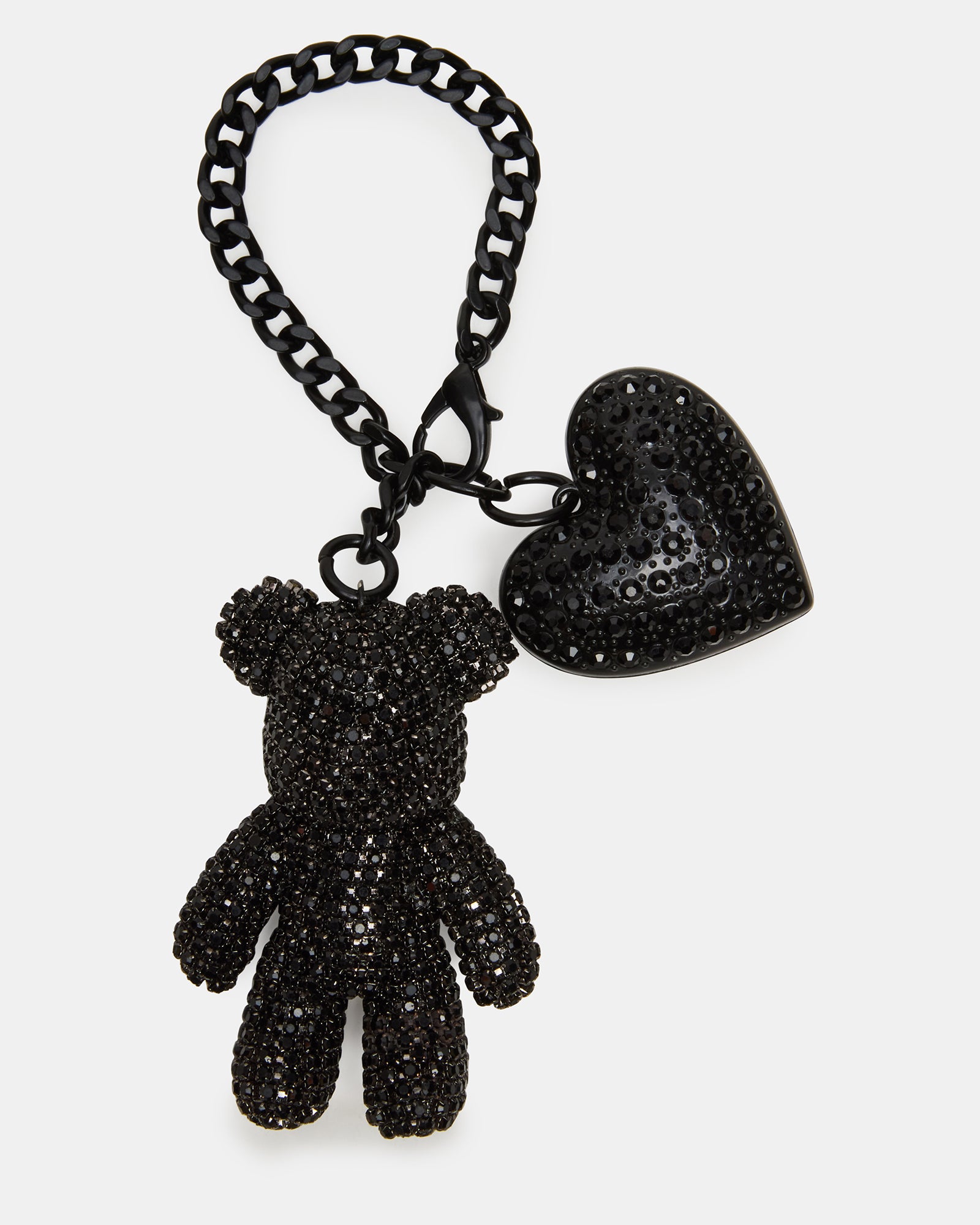 Black rhinestone teddy bear bag charm on a Coach handbag