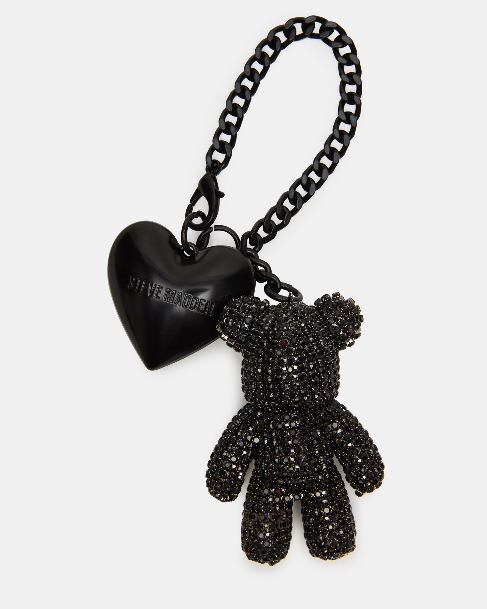 Teddy bear charm attached to keys against a soft background