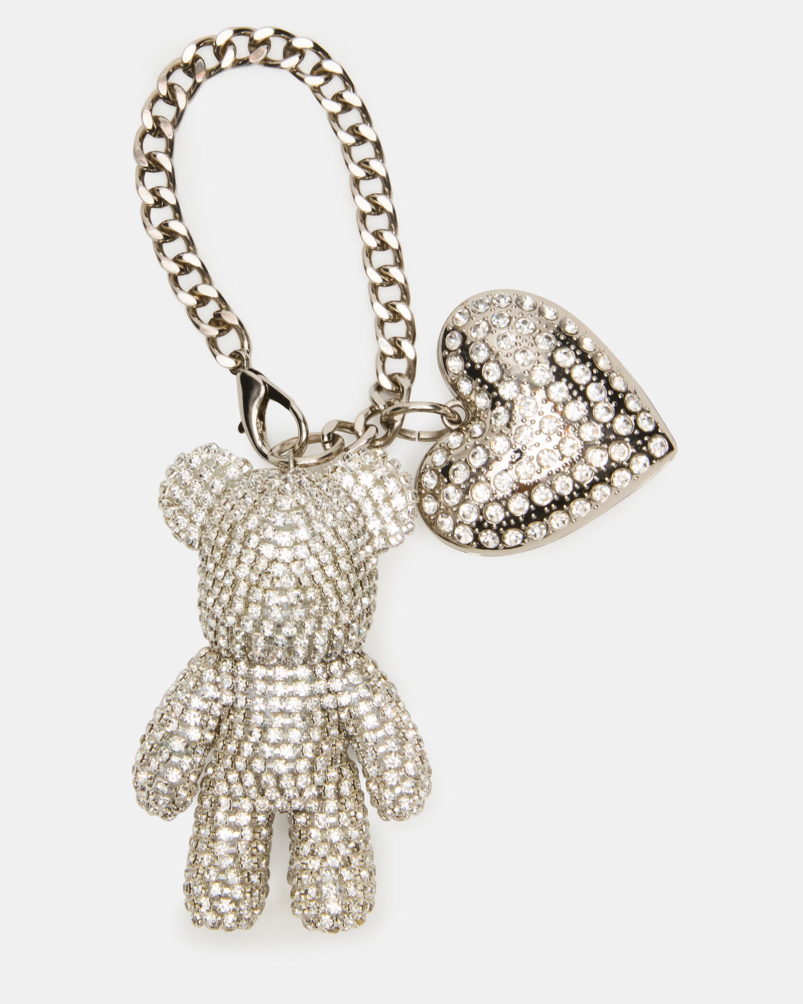 Silver teddy bear charm attached to a Coach handbag