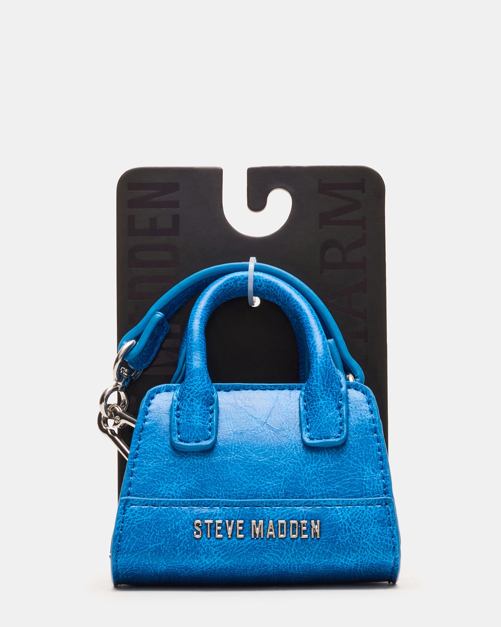 Mini tote bag charm hanging from a coach tote for everyday style