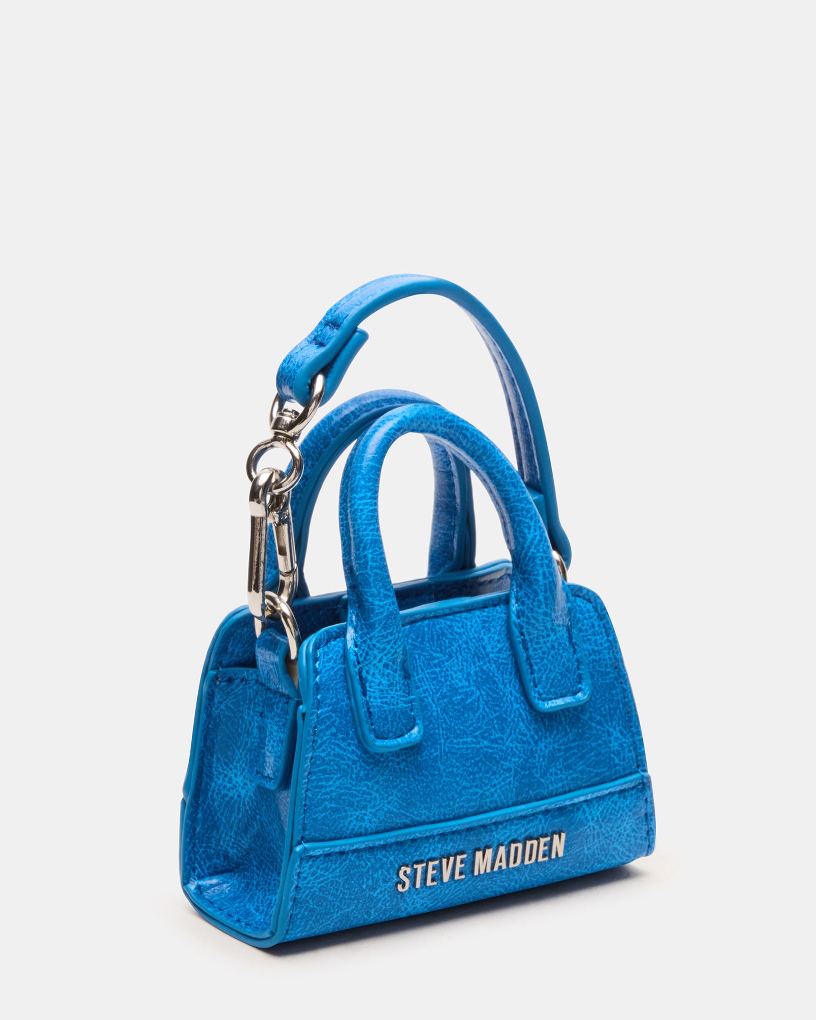 Mini tote bag charm hanging from a coach tote for everyday style