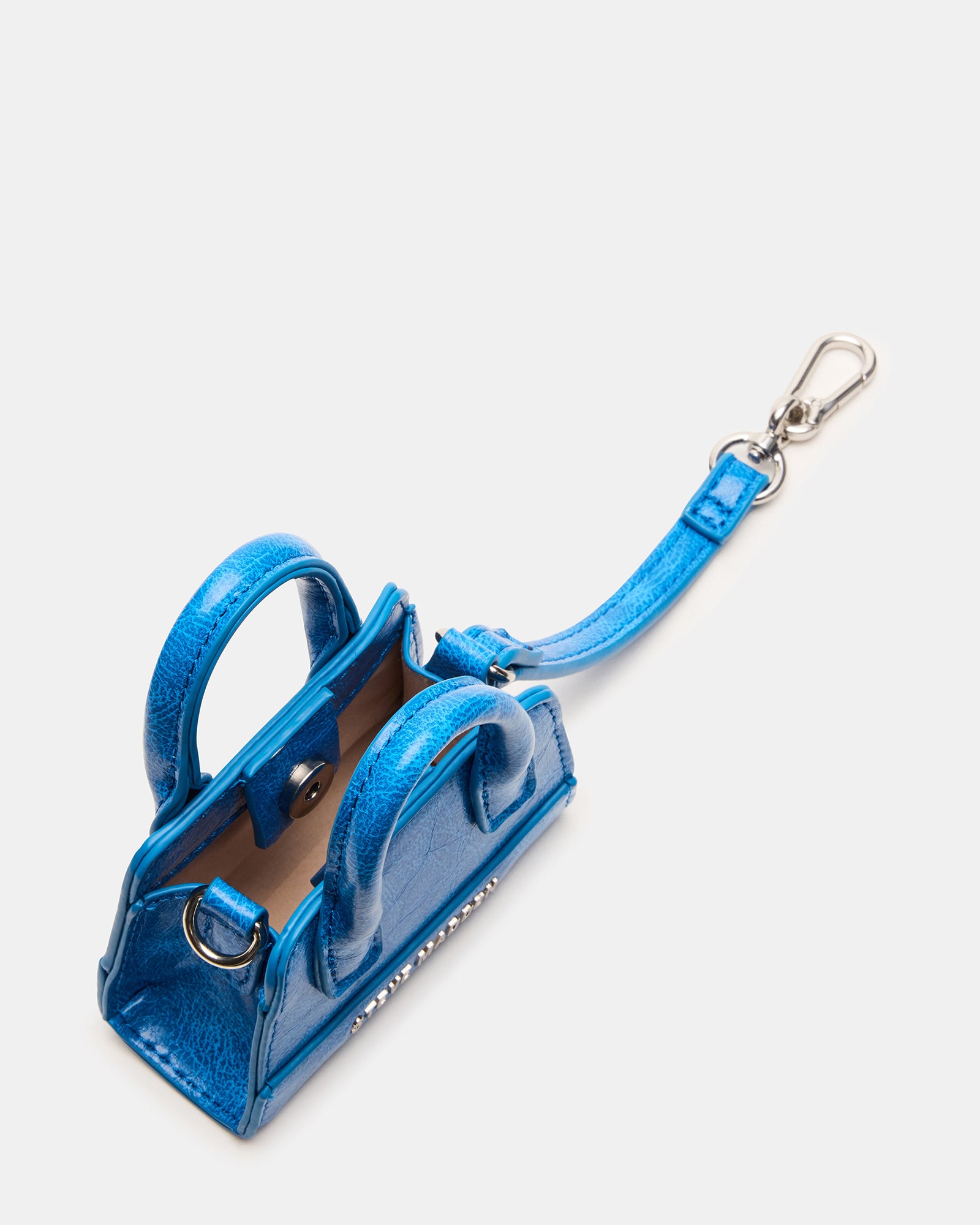 Blue mini tote bag charm attached to a tote bag, stylish accessory
