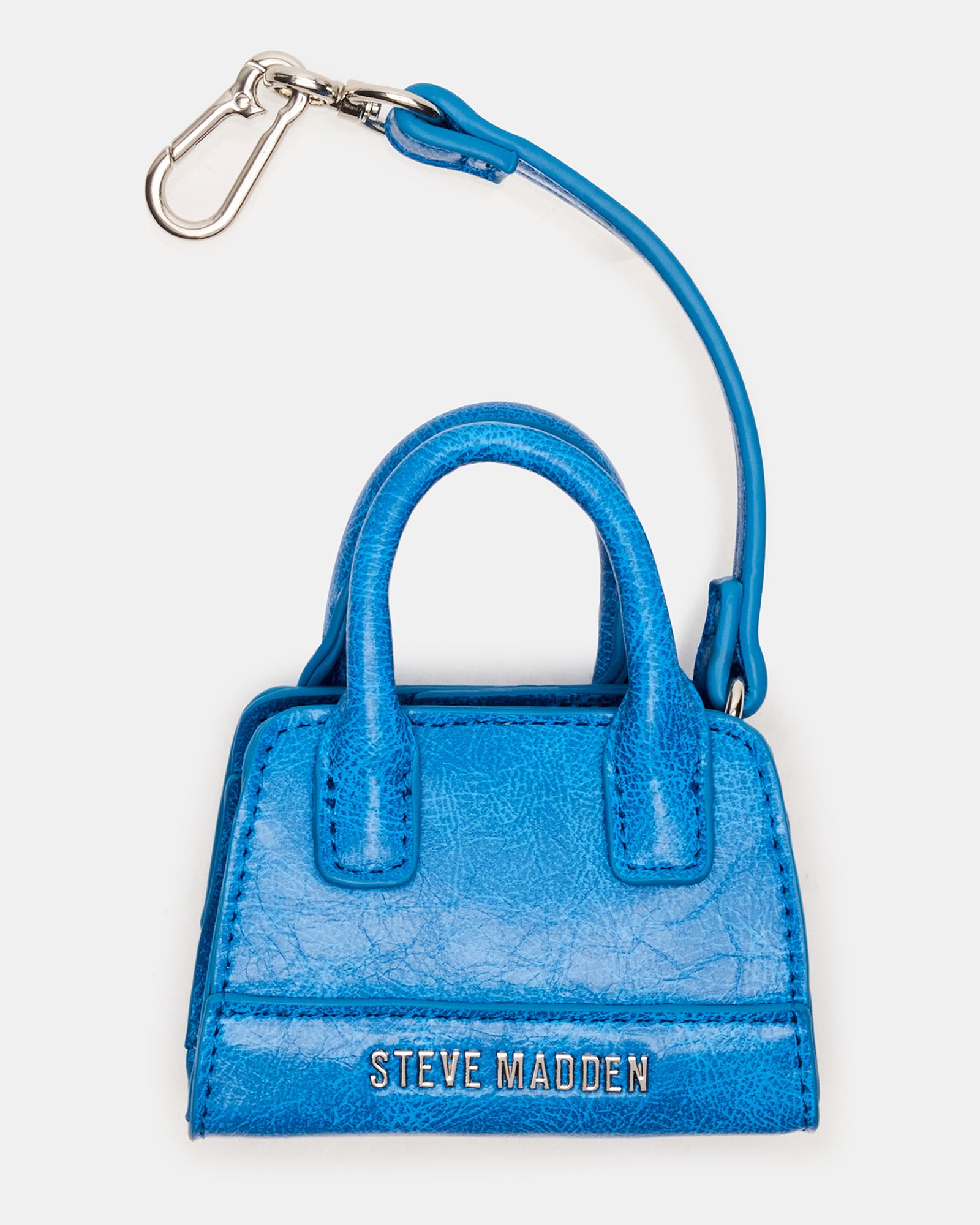 Blue mini tote bag charm attached to a tote bag, stylish accessory