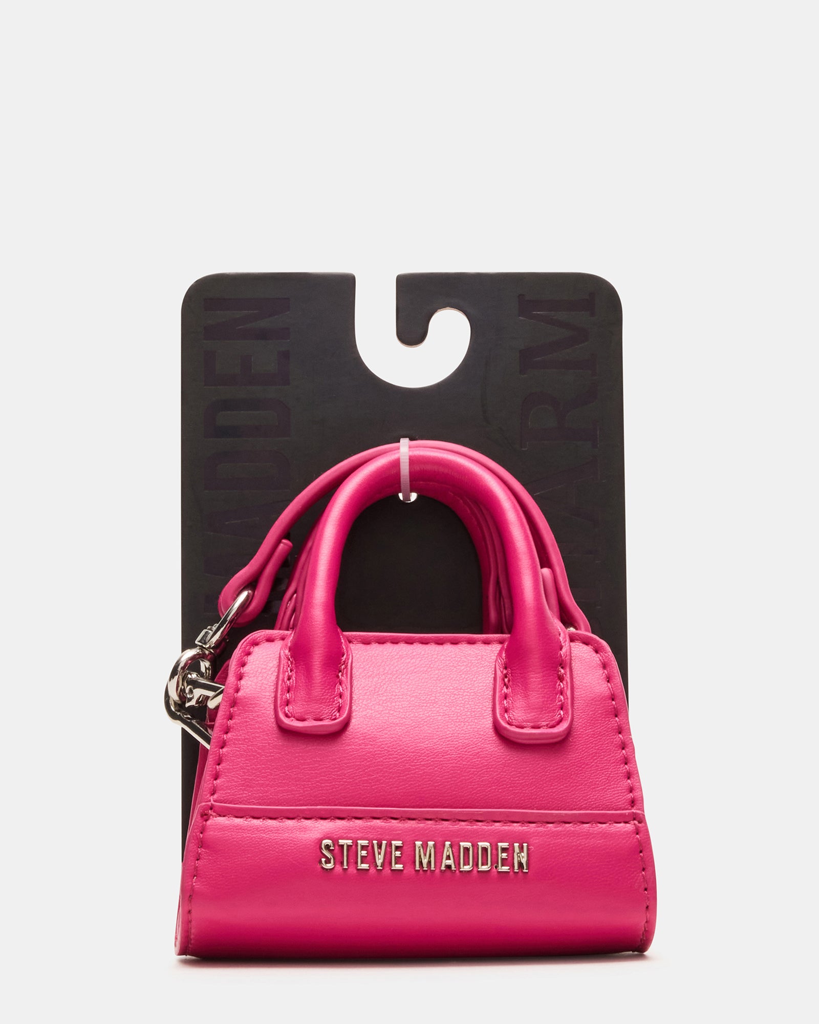 Fuchsia bag charm showcased in a stylish setting.