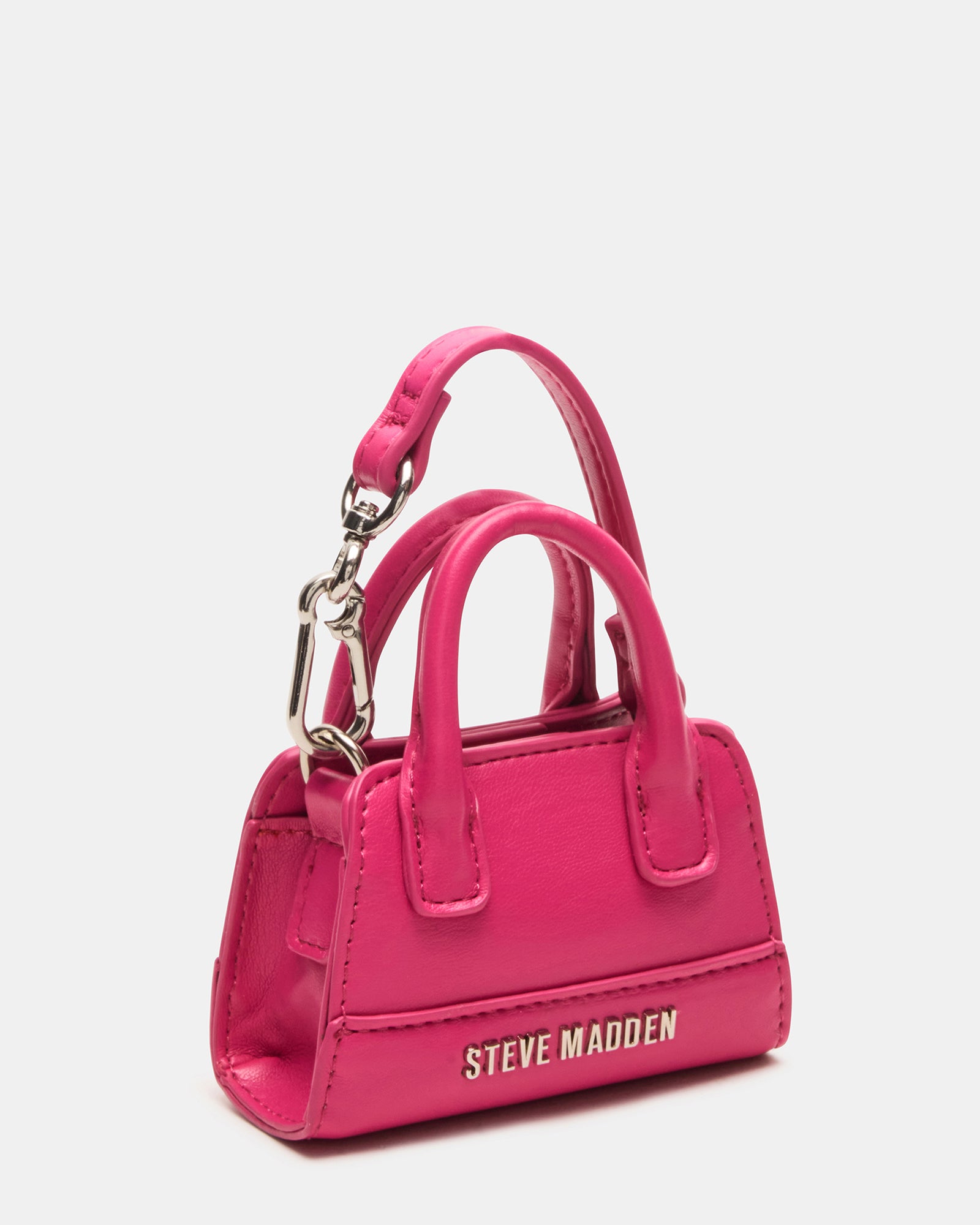Fuchsia bag charm showcased in a stylish setting.