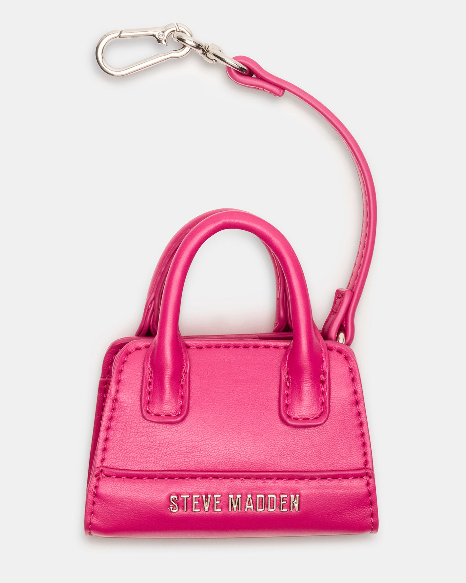Close-up of fuchsia mini tote bag charm attached to a handbag.