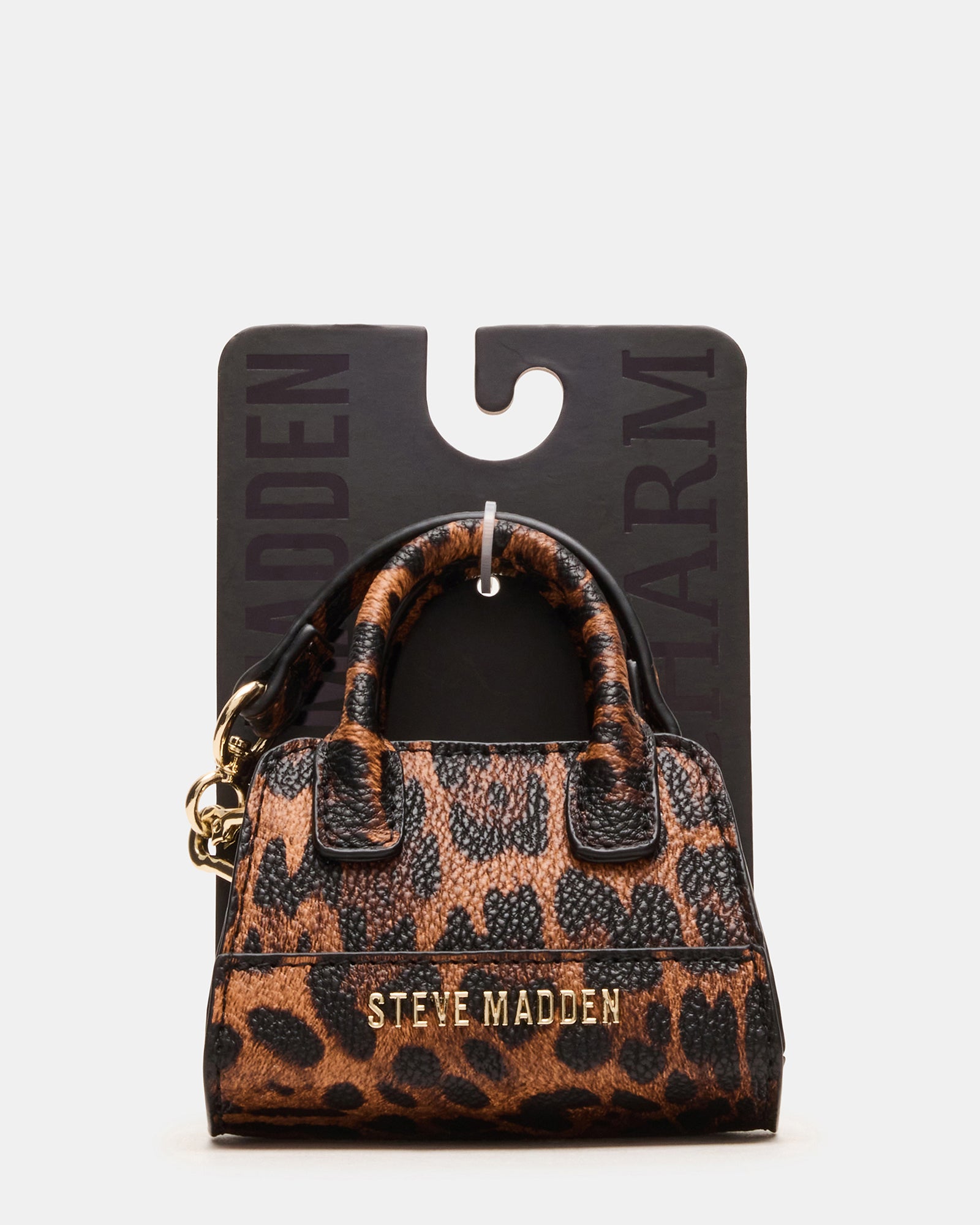 Stylish charm paired with a Goyard tote bag for contrast