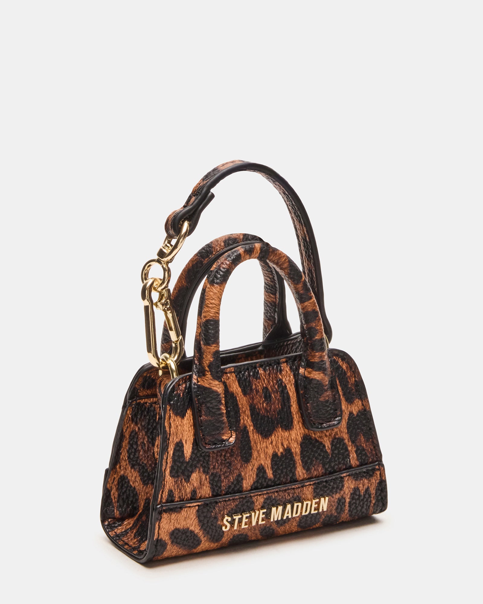 Stylish charm paired with a Goyard tote bag for contrast