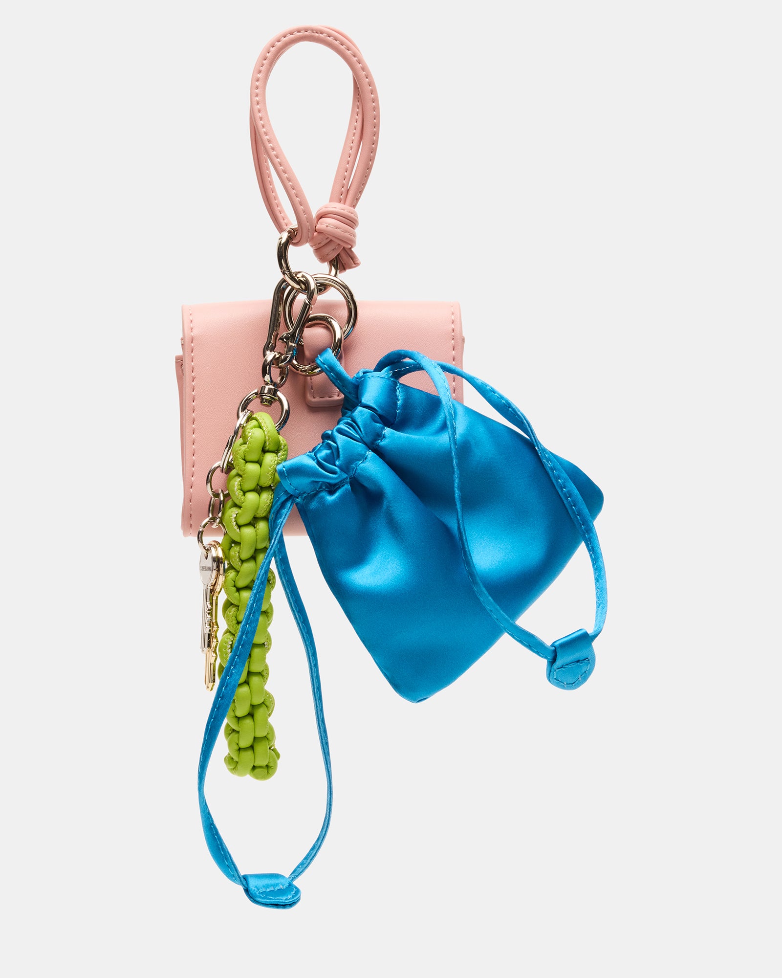 Colorful travel bag charm in coral multi attached to a suitcase