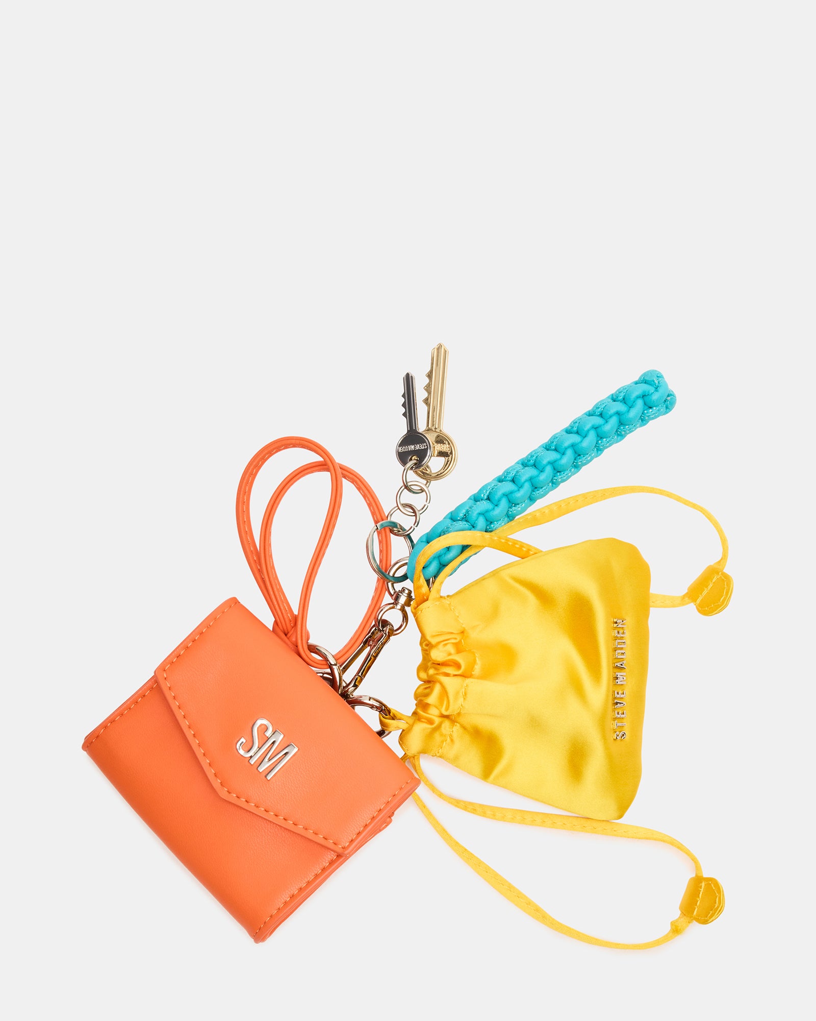 Vibrant orange multi coach bag charm hanging on a travel bag, highlighting its colorful design