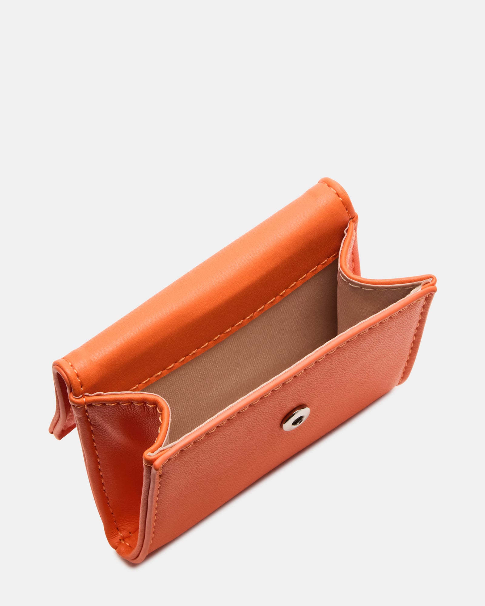 Close-up of the mag snap closure and key ring charm on a stylish coach bag accessory