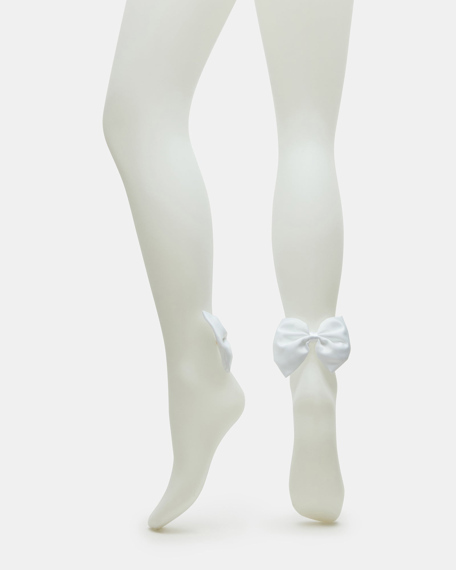Sheer white bridal tights with bow detail, perfect for wedding day