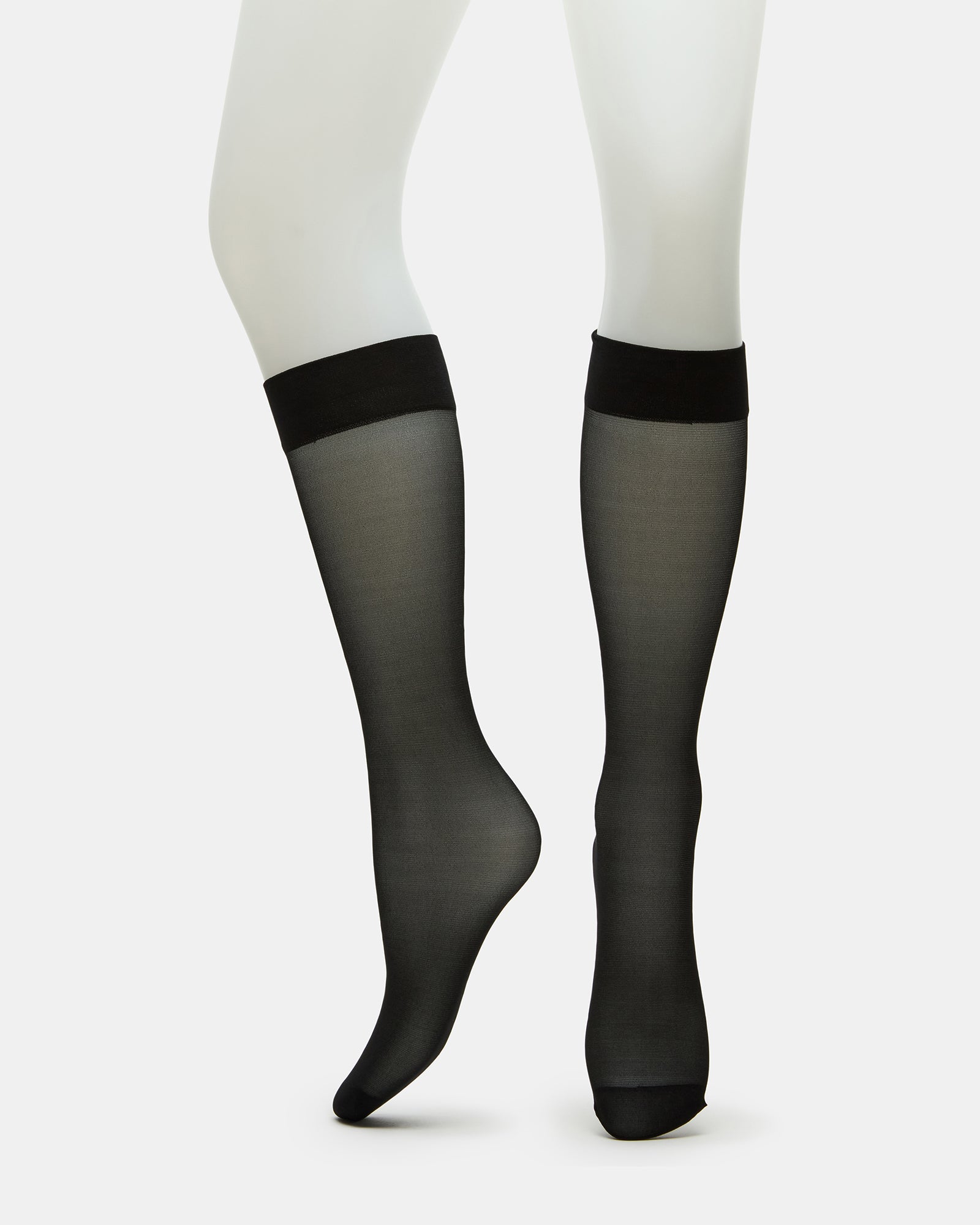 Three pairs of sheer black knee high socks displayed elegantly.