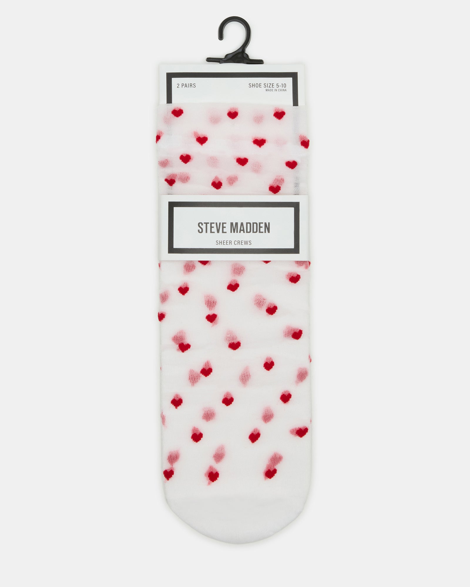Pair of sheer white ankle socks with heart design displayed on a wooden surface