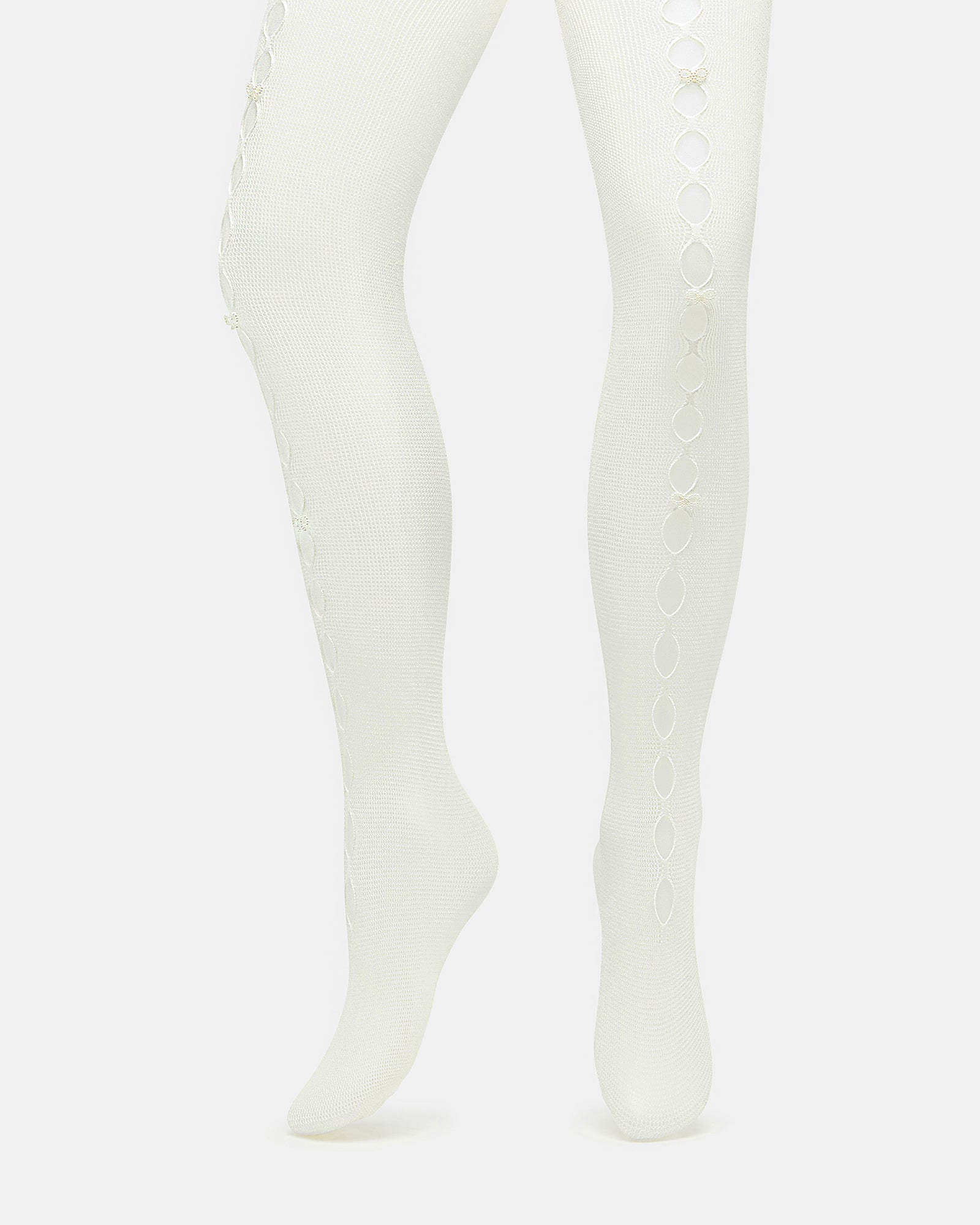 Model wearing off-white pearl tights with ballet flats in natural light