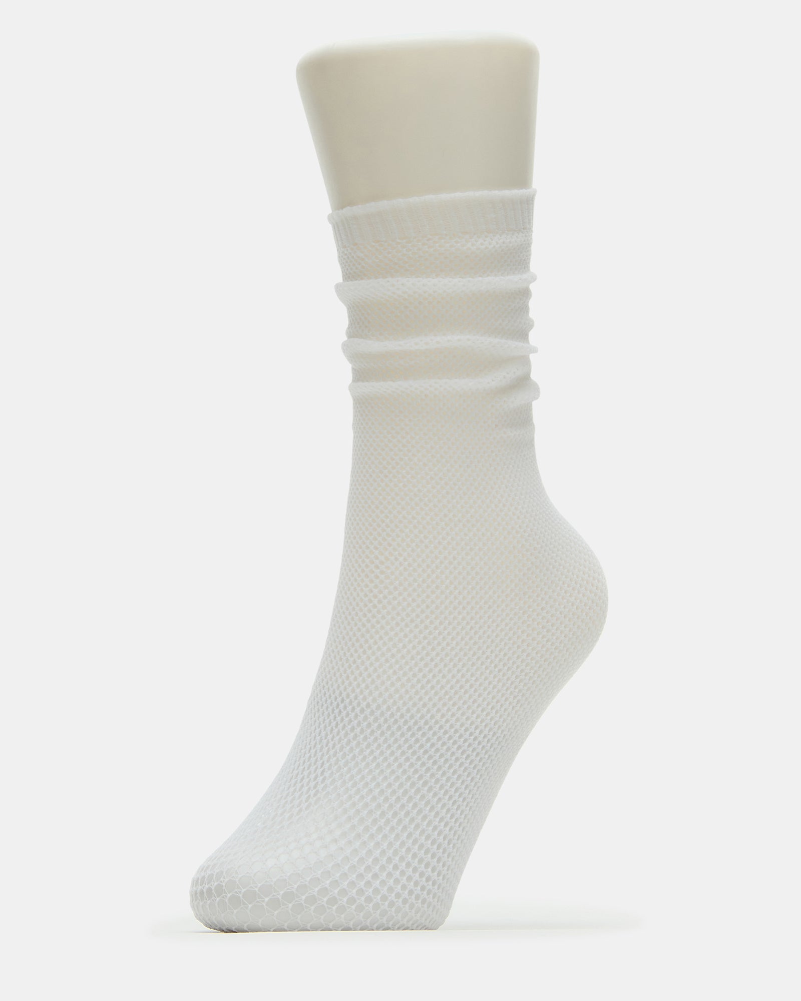 Side view of crew sock with fishnet texture layered under ankle boots