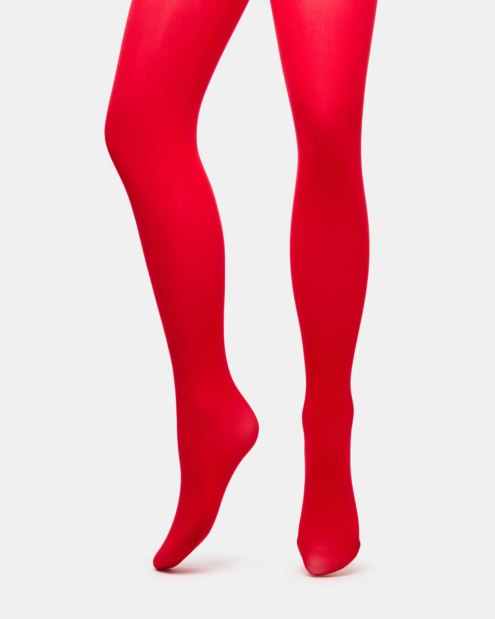 Front angle of radiant red tights paired with ankle boots