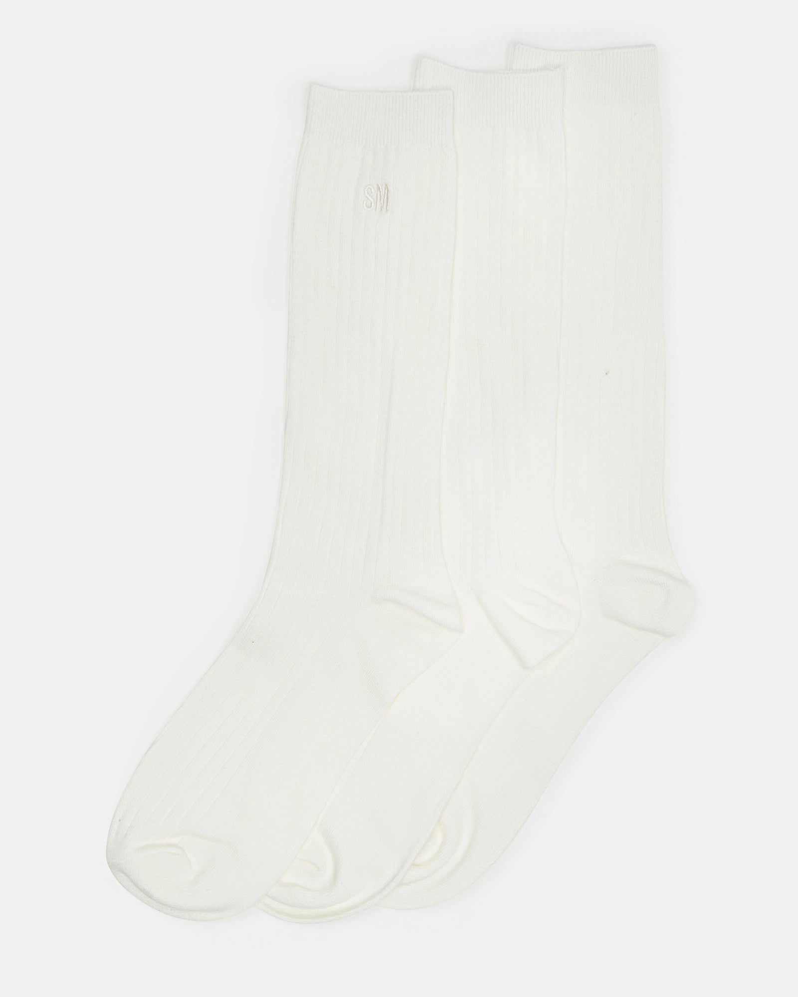 Close-up of ivory crew socks showcasing the soft cotton material.