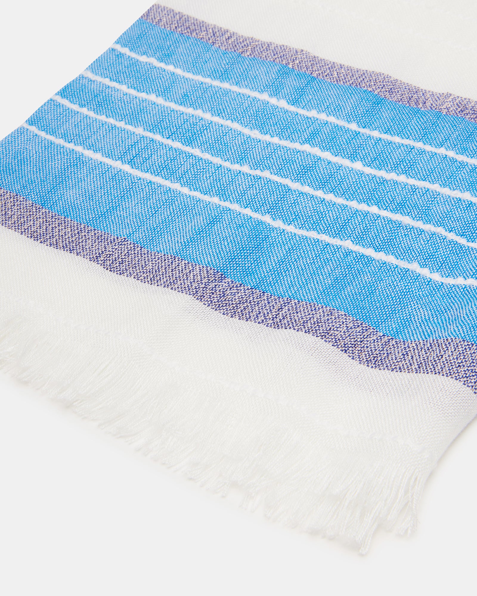 Flat lay of the vibrant blue striped scarf showcasing its bold pattern and size