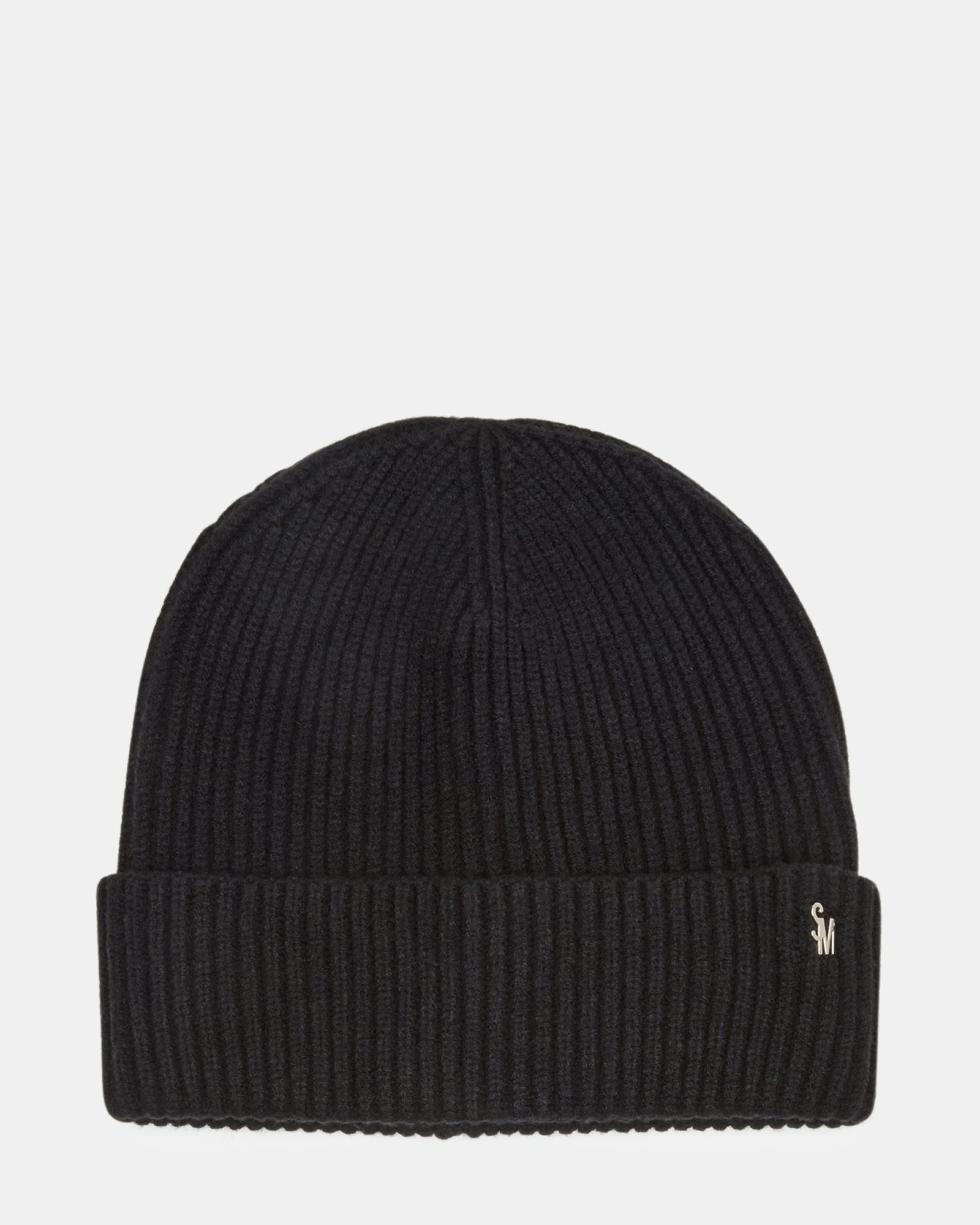 Black ribbed beanie folded on a city park bench