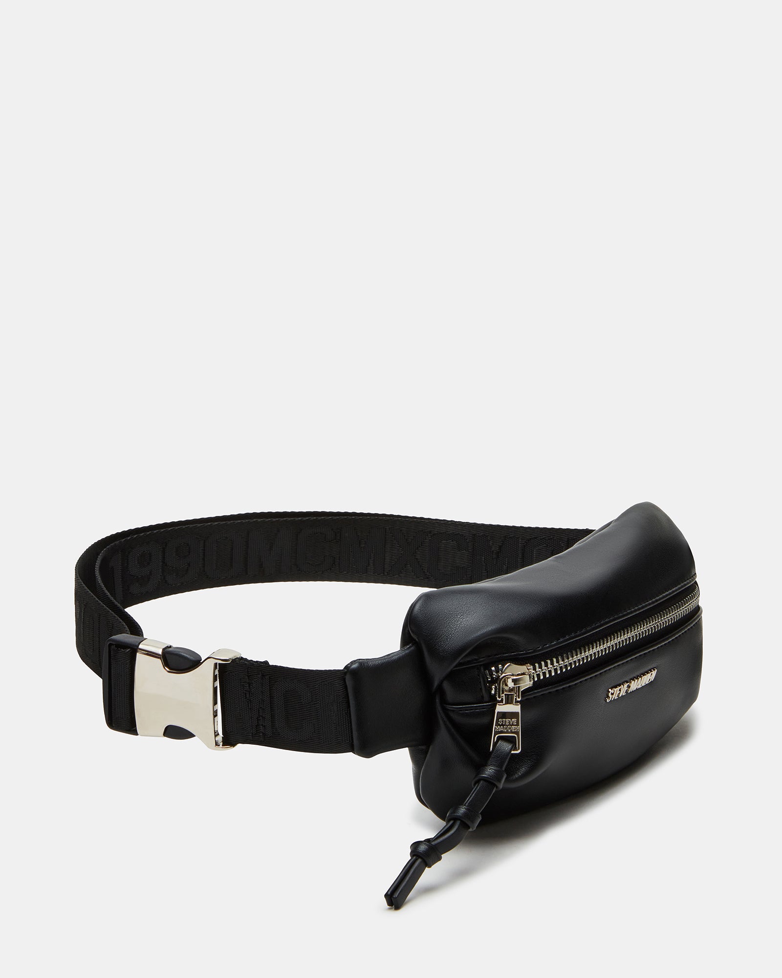 Black pleated baguette belt bag worn crossbody in urban setting