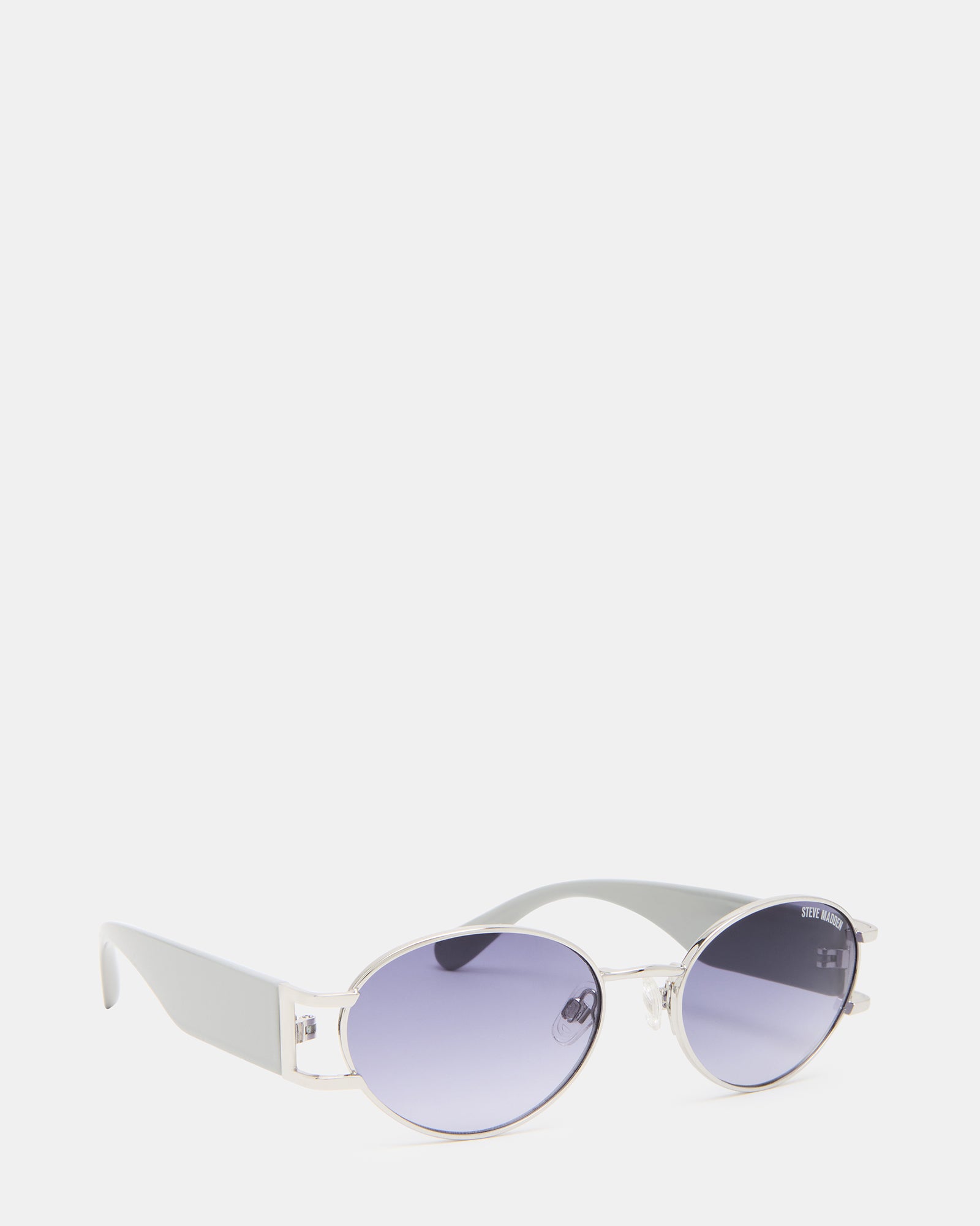 Man wearing smoke gradient sunglasses with silver frame while walking downtown