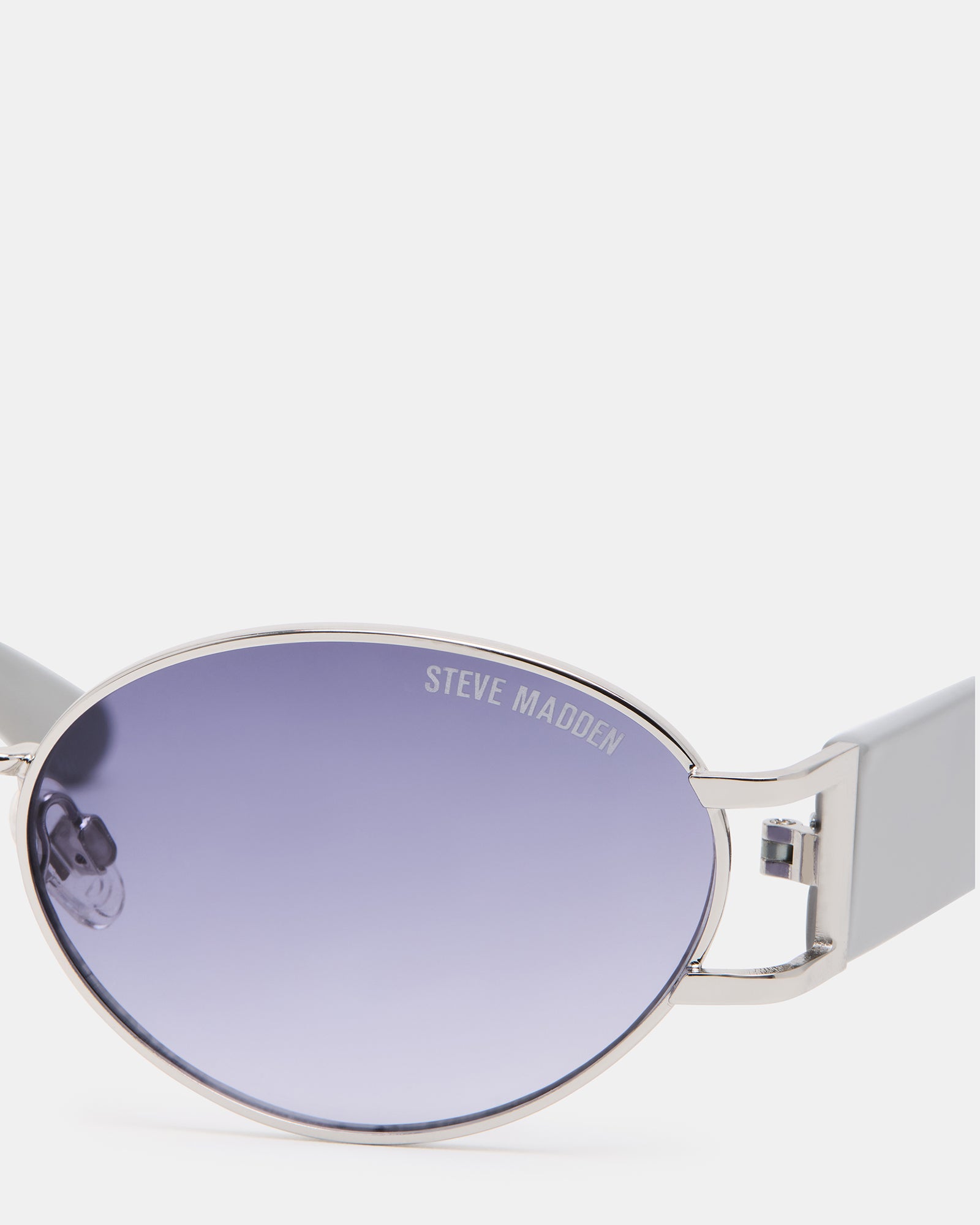Top-down view of silver aviator sunglasses on a leather Kentucky road-trip bag
