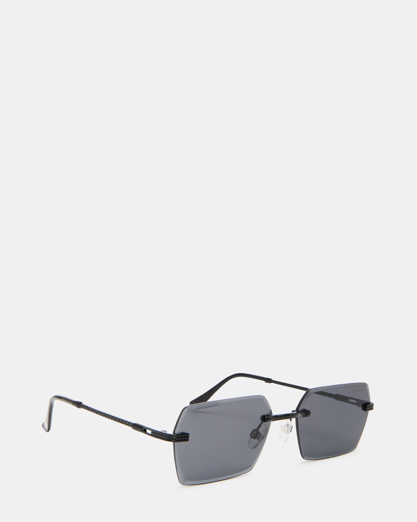 Finnian shades placed on a sandy beach with ocean backdrop