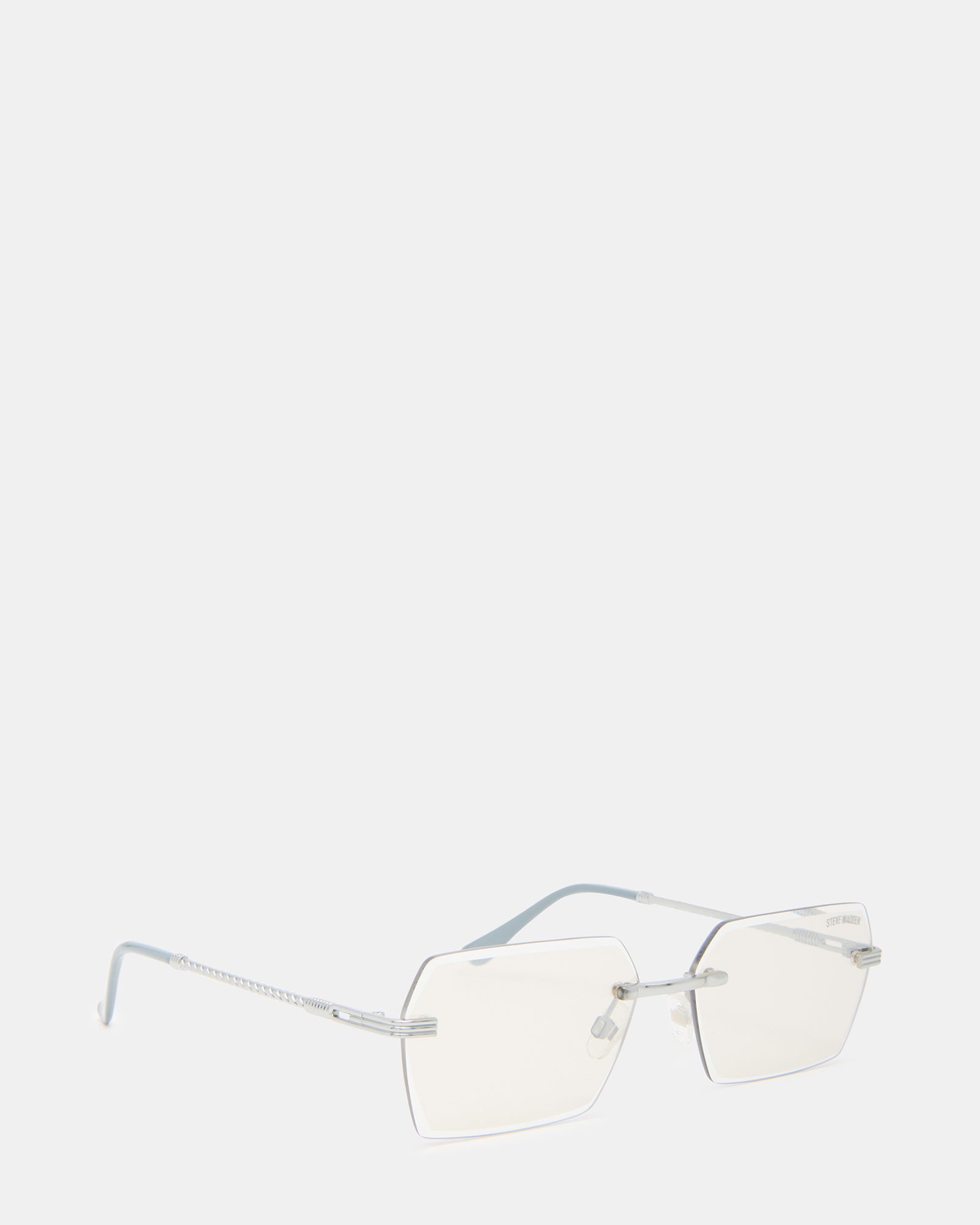 Finian silver aviator sunglasses laid on a stylish wooden surface