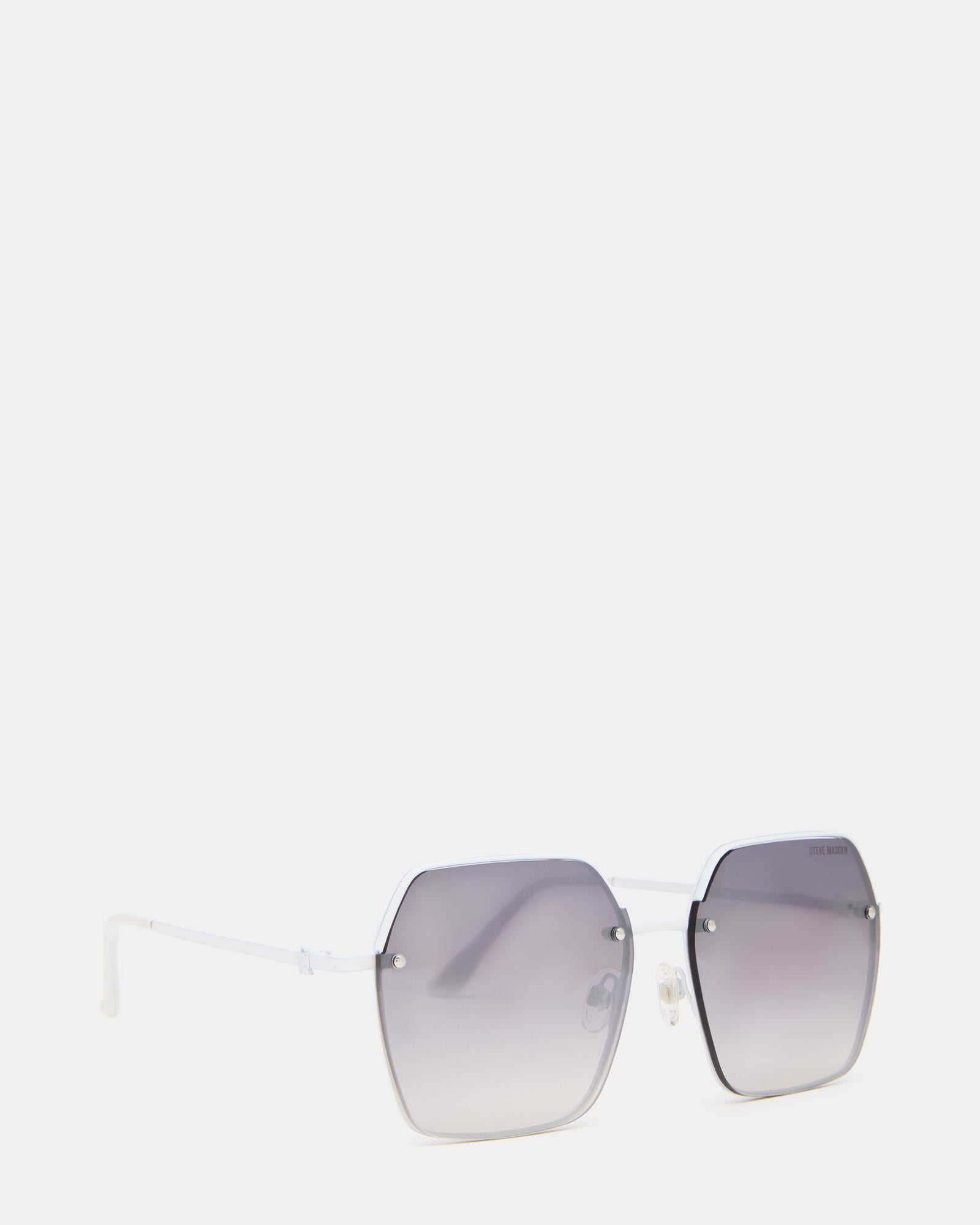 Stylish white frame sunglasses displayed on a table with a city backdrop.
