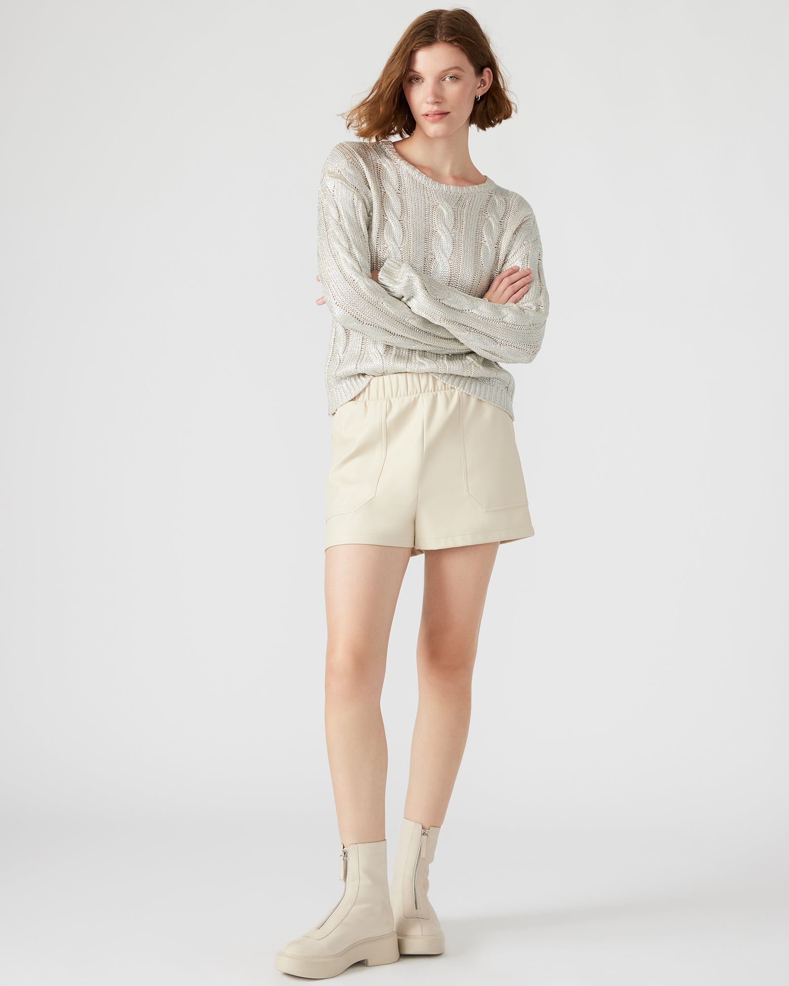 Close-up of faux leather shorts highlighting material detail and stitching.