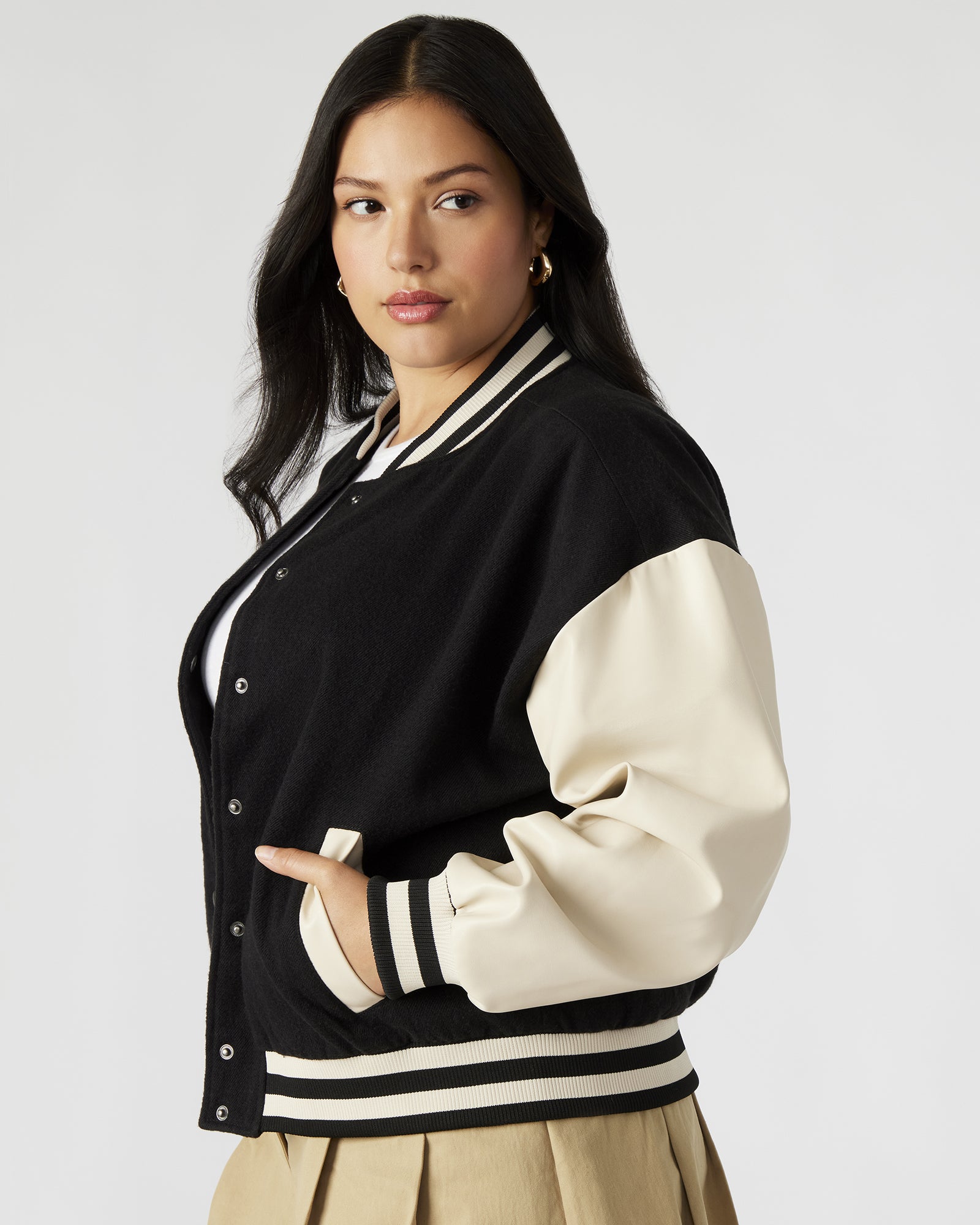 Model wearing the Retro Varsity Black Bomber Jacket styled for a casual day out.