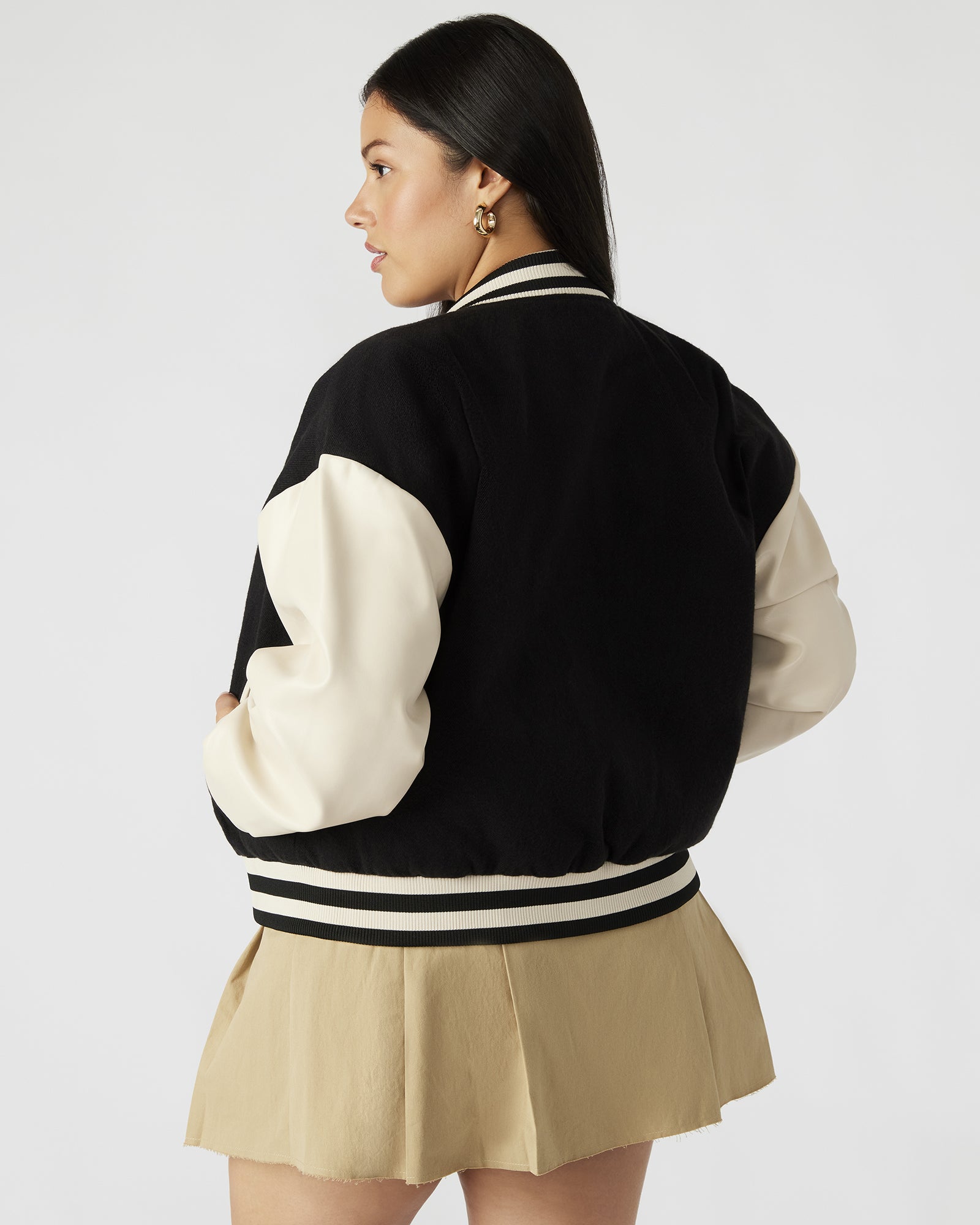 Front view of the Retro Varsity Black Bomber Jacket with striped trim and snap buttons.