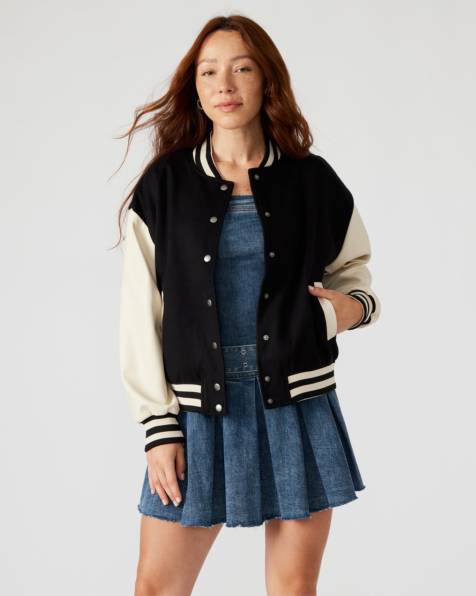 Front view of the Retro Varsity Black Bomber Jacket with striped trim and snap buttons.