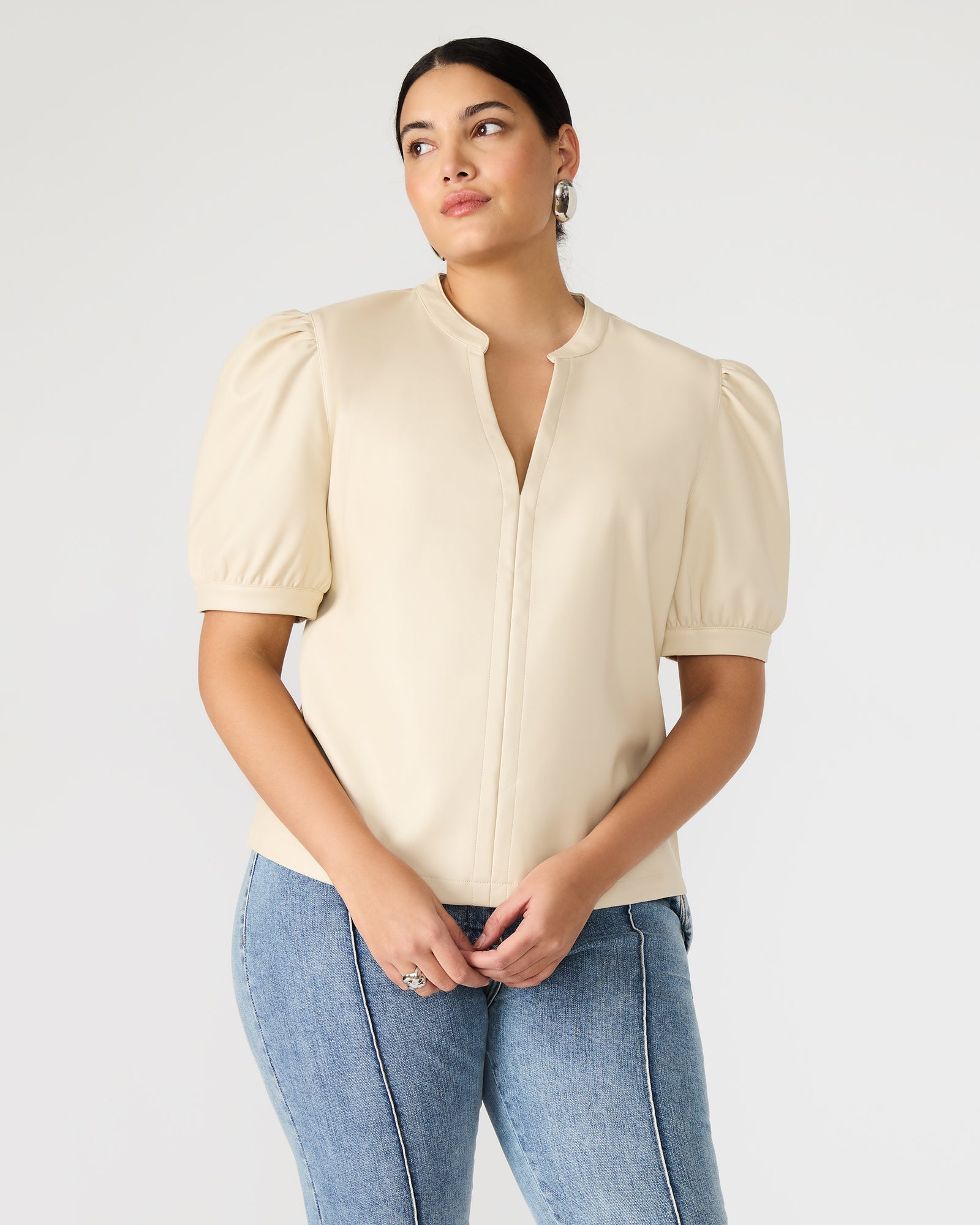 Front angle of V-neck faux leather shirt with bone-tone finish