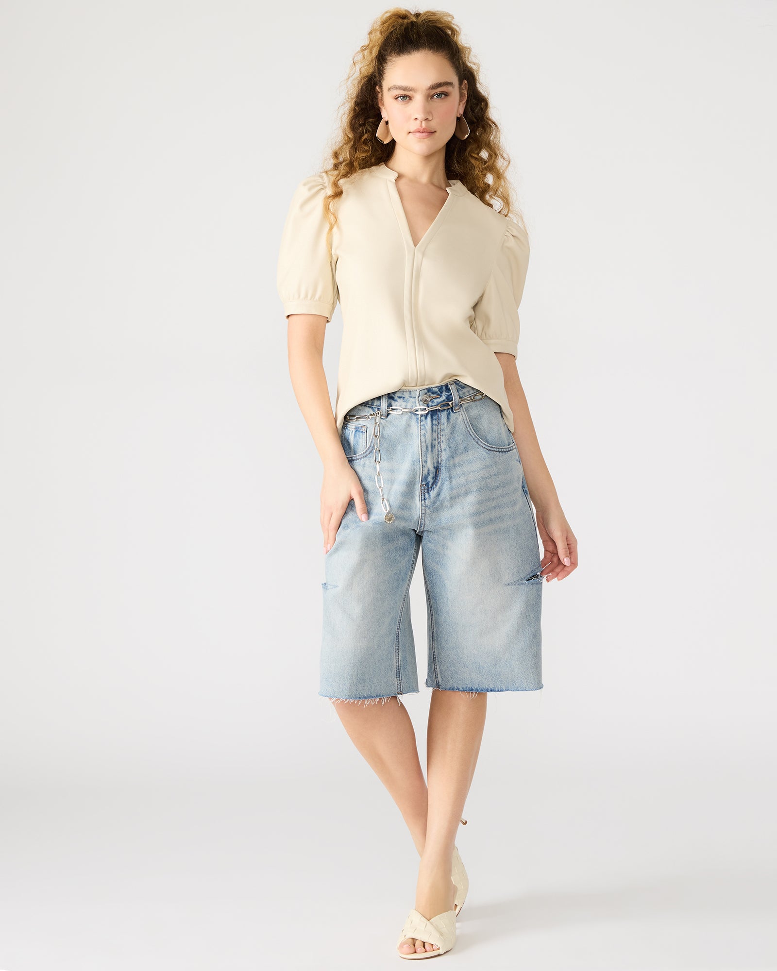 Front angle of V-neck faux leather shirt with bone-tone finish