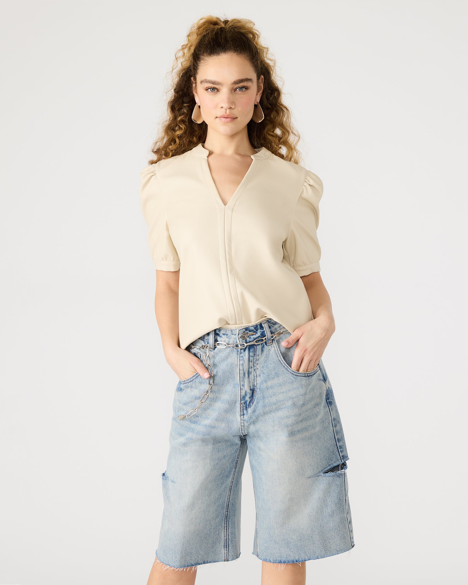 Back view of womens puff sleeve blouse worn casually