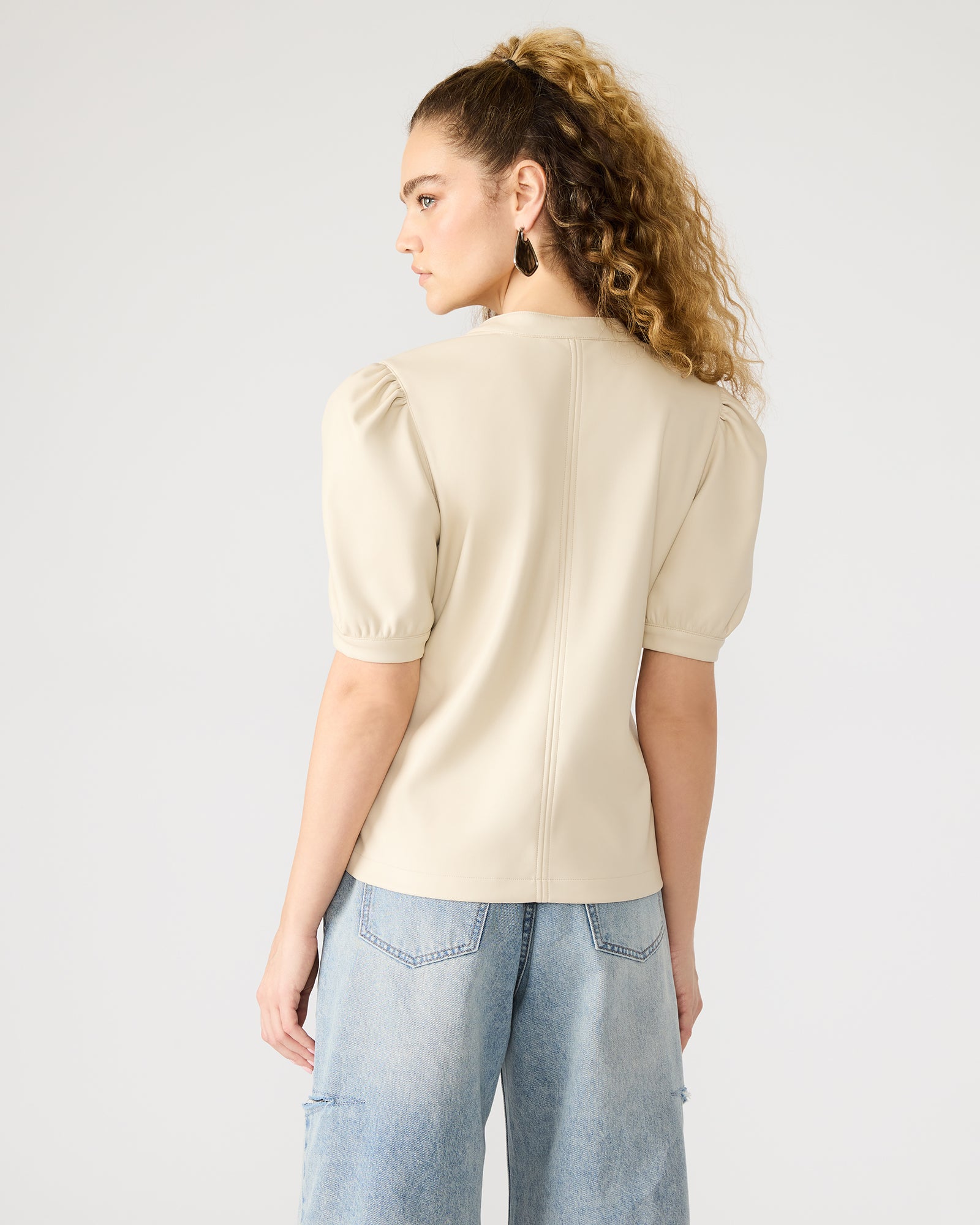 Close-up showing faux leather tank top texture and stitching details