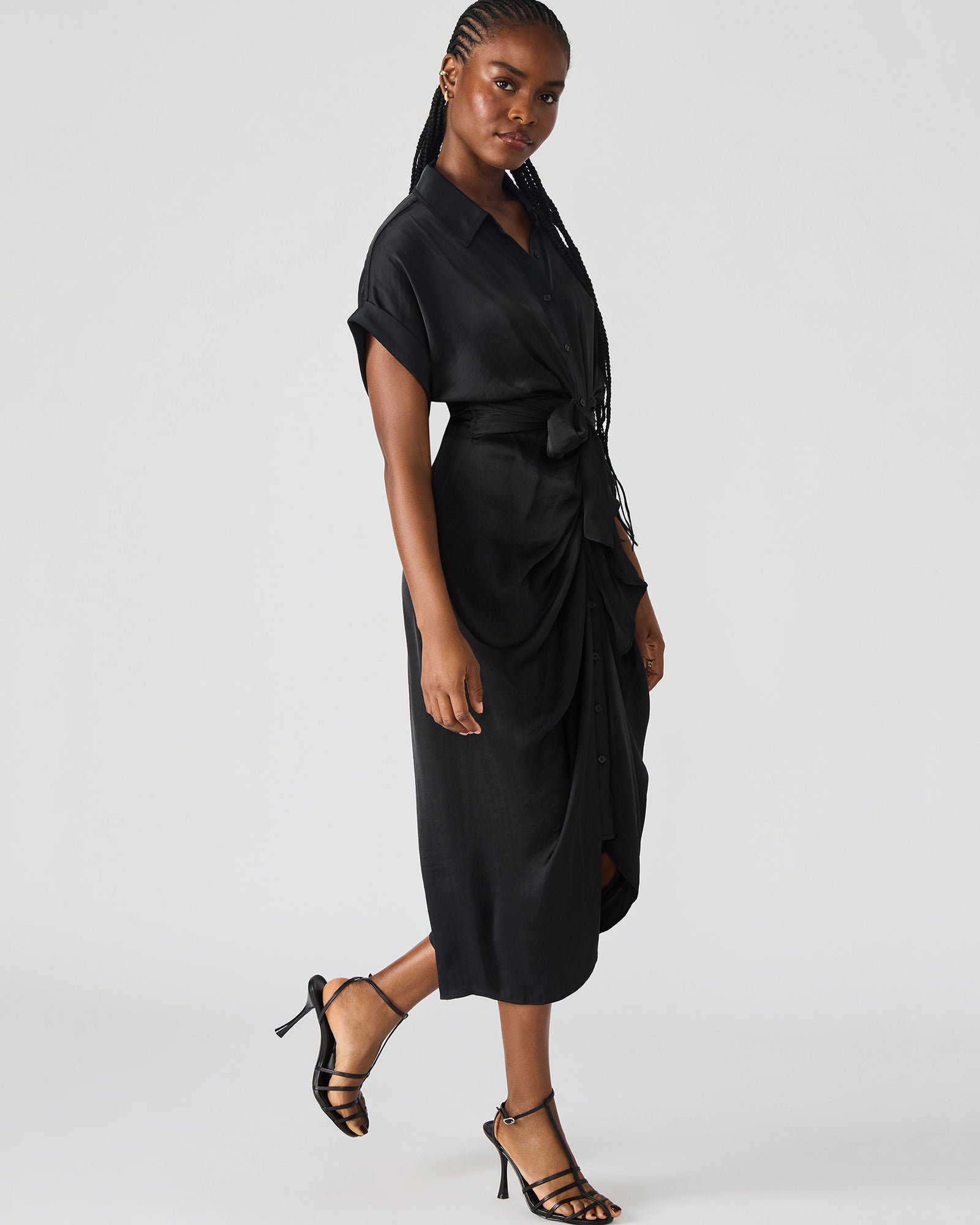 Side view of the Tori black midi shirt dress highlighting the high-low hem.
