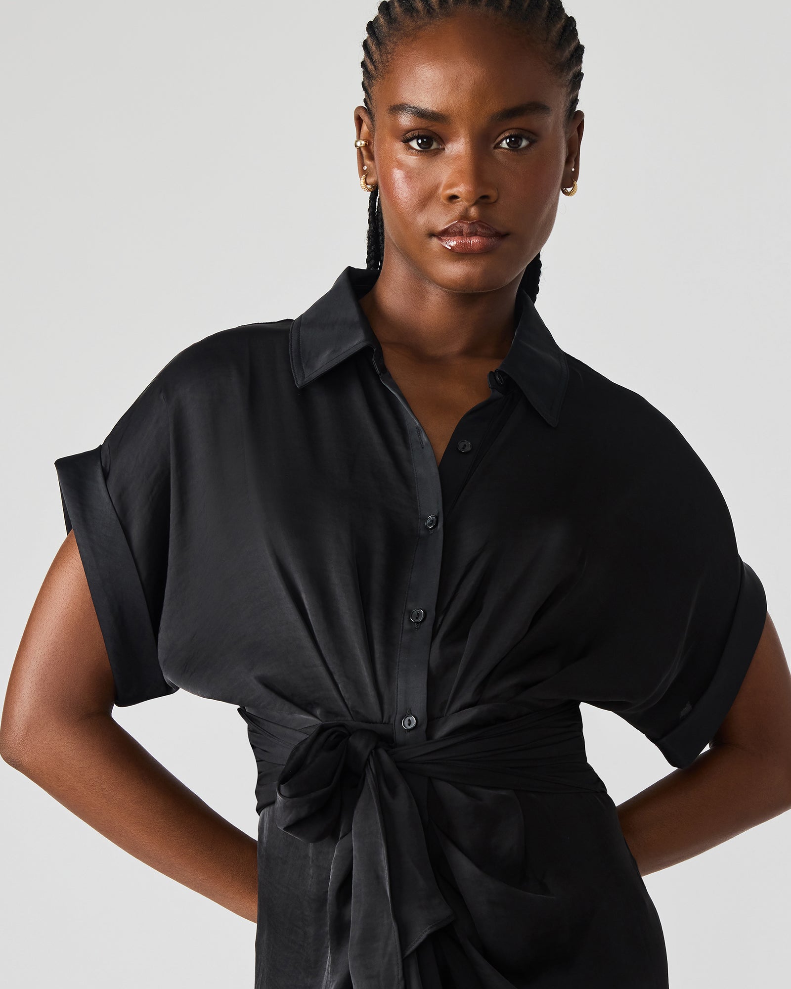Close-up of the rolled collar and cuffed sleeves of the Tori black midi dress.