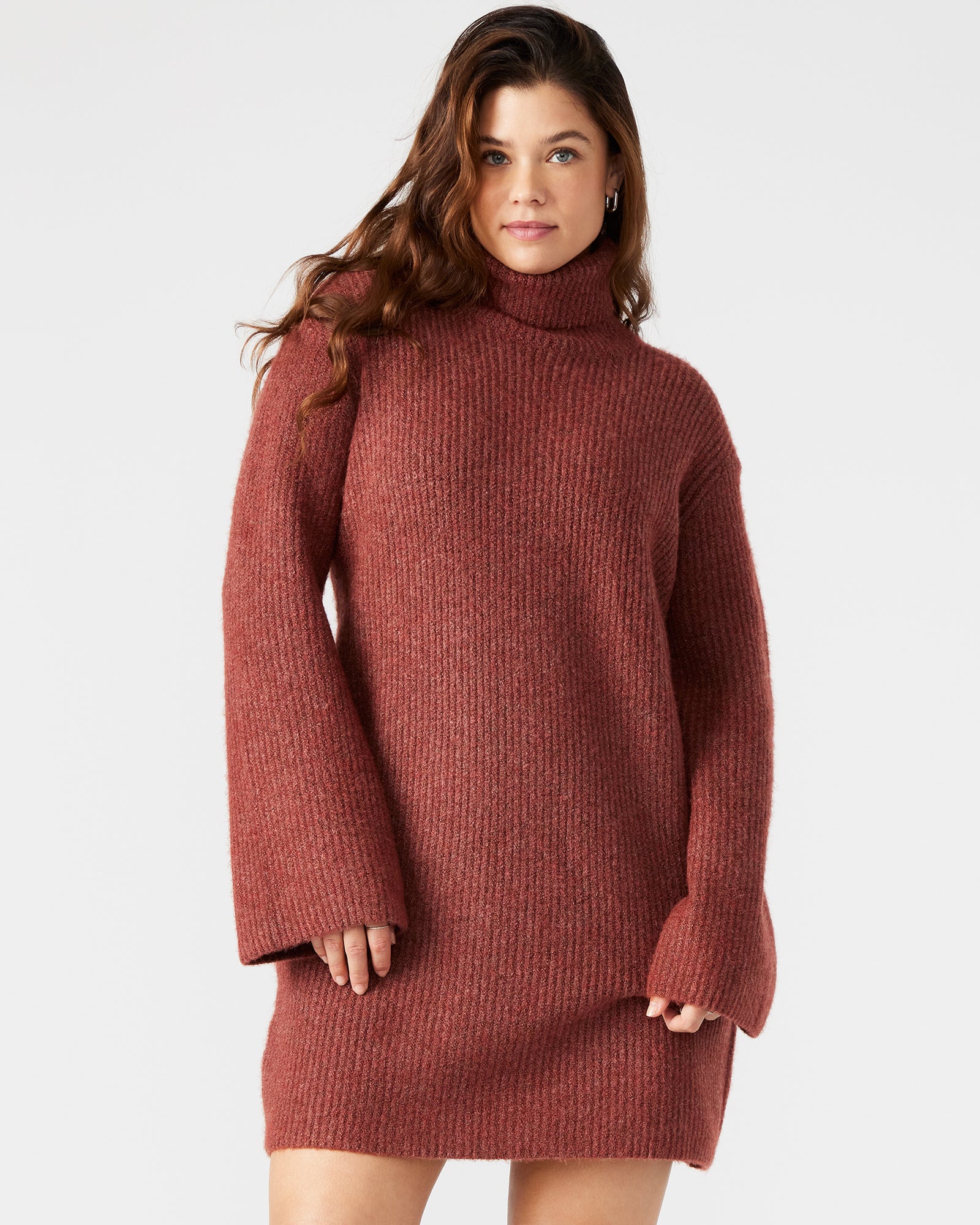 Side view showcasing the flared sleeves of the rust sweater dress.